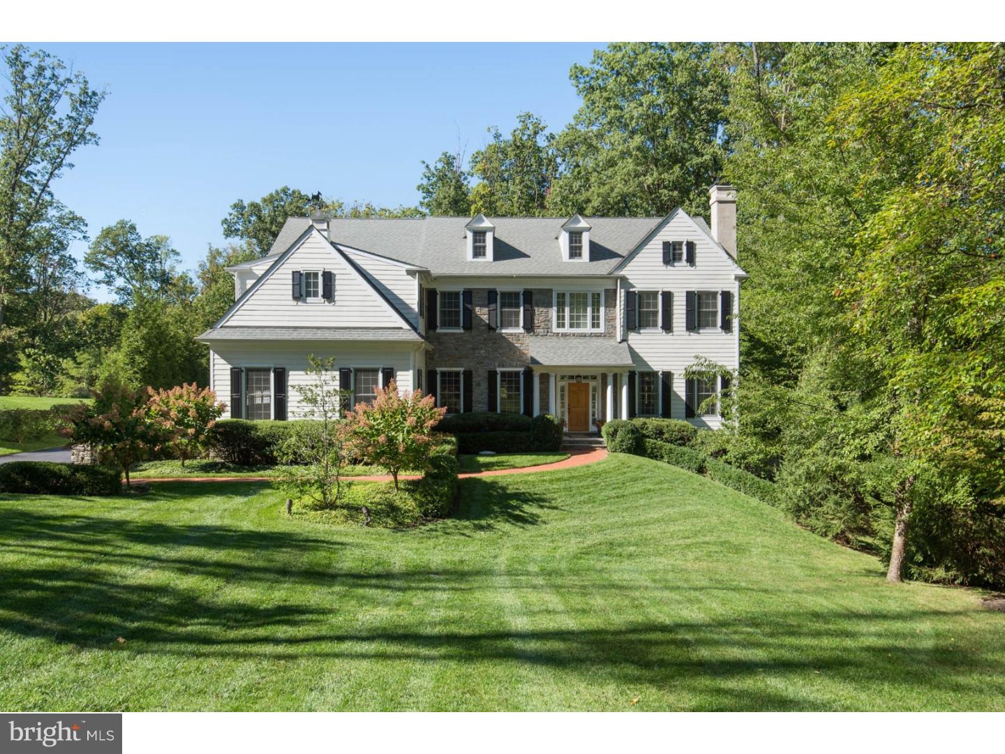 Enjoy comfort and refinement on a quiet cul-de-sac, with private grounds backing to a 1.86 acre wooded preserve! A Belgian block-lined drive to a built-in 3-car garage, lovely landscaping & brick walkways add to the curb appeal of this wonderful family home. The picturesque surroundings are enhanced by a large saltwater pool with a spa & waterfall and peaceful patio with a built-in gas grill providing hours of outdoor enjoyment. The excellent neighborhood is friendly and convenient, close to shops, restaurants, the train station, and award-winning schools like TE Middle School & Conestoga High. Inside the home, a gracious front-to-back entry foyer with rear glass doors to the pool patio introduces the beautiful detailing found throughout. Hardwood floors, wainscoting, moldings, arched doorways, airy 10' ceilings & generous windows lend special touches of elegance. A spacious living room with a fireplace and formal dining room afford a perfect backdrop for entertaining. The top-of-the-line kitchen with Thermador & Miele appliances and a furniture-like center island with seating opens to a sunny breakfast room offering even more space for family and guests to gather. Glass doors open to the rear patio, pool & yard for hosting seamless indoor-outdoor parties. The main level also presents a step-down family room with 11' coffered ceilings and a wood-burning fireplace for cozy nights, and a den/library with French doors. The upstairs master suite is a luxurious retreat with a light-filled bedroom, private sitting room, 2 walk-in closets, and spa bath featuring his & her sink vanities, a windowed soaking tub alcove & huge walk-in tiled shower. Also on the second level are 4 additional well-sized bedrooms, 3 full baths and a laundry room. The third floor houses 2 more bedrooms, an open sitting room and full bath. The finished lower level has something for every mood, like a great room with a granite-top wet bar & wine closet, media & play areas, a big home gym and a spacious full bath.