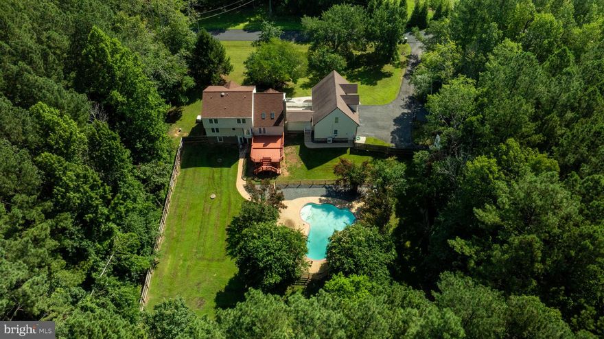 Welcome to 159 Marchant Drive, a beautifully maintained 6-bedroom, 3.5-bath custom colonial situated on 3.5 landscaped acres in the sought-after Blake Farm community—no HOA. With more than 4,000 square feet of finished living space, this home features freshly refinished hardwood floors and new interior paint throughout.
The main level offers a comfortable layout - It includes a separate family room, formal dining room, bright living room, and an updated kitchen with granite countertops, stainless steel appliances, and a breakfast area. A large mudroom located just off the oversized three-car garage adds everyday convenience.
Upstairs, the spacious primary suite includes a private office or sitting area, a walk-in closet, and a well-appointed en-suite bath. Three additional bedrooms and a full bathroom complete the upper level.
The finished basement expands the living space with two potential bedrooms and a full bathroom, making it well suited for guests or multi-generational living. A cozy TV room and a separate movie room with a built-in bar—currently one of the potential bedrooms—create great spaces for entertaining or unwinding. The walk-out basement leads directly to the backyard and pool area. Two large storage rooms provide ample space for organization.
Outdoor features include a newly refinished deck overlooking a fully fenced backyard with an in-ground pool and spa, screened gazebo, and chicken coop. Additional amenities include a detached one-car garage, storage shed, and mature landscaping. Above the main garage, a large unfinished space offers the opportunity for a future apartment, office, or studio.
Conveniently located near commuter routes, shopping, and Quantico, this property offers privacy without sacrificing accessibility. A rare opportunity in Blake Farm, 159 Marchant Drive delivers space, flexibility, and freedom—without HOA restrictions.
Schedule your private tour and see everything this property has to offer.