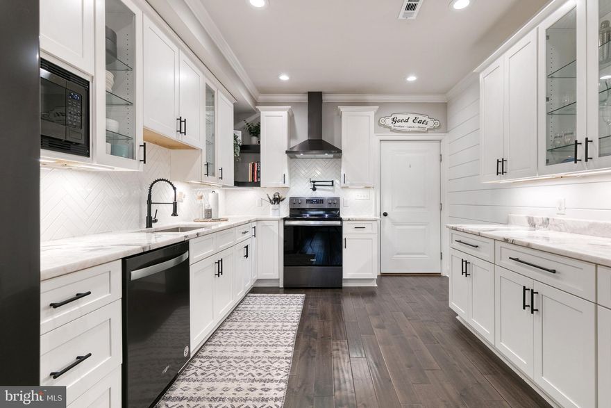 This gorgeous, nearly-new Canton row home boasts 2 bedrooms, 2 full bathrooms, a rooftop deck and a 1-car garage! As soon as you step through the front door you'll fall in love with the elegant finishing touches throughout this home, like the coffered ceilings in the living room, white tile backsplash, white cabinets and gorgeous counter tops in the kitchen, and the absolutely stunning bathrooms upstairs. The primary bedroom features a shiplap wall, large exterior window, ceiling fan, and a contemporary glass window between the bedroom and the bathroom. There's plenty of storage space with a huge walk-in closet in the primary bedroom, a closet in the second bedroom, and a storage closet under the stairs. Enjoy fresh air and sunshine on the rooftop deck and never search for a parking space again thanks to the 1-car garage. This extraordinary Canton home could be yours!