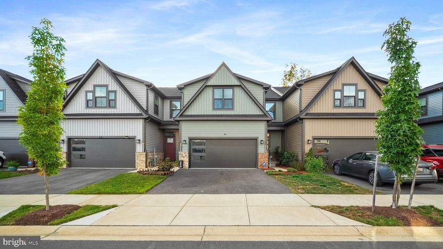 Welcome to this charming home located in a vibrant 55+ community, offering the perfect blend of comfort and convenience. This spacious residence features over 3,000 sq feet of living space.  This home is only two years young, so no stress about appliances or system failures because the home is almost new.  There is no waiting for your home to be built, or adding a deck later. Everything is already included.

The primary bedroom and full bath are conveniently situated on the first level, making everyday living easy and accessible. Beautiful hardwood floors flow throughout the first level and kitchen, adding warmth and style. The finished basement provides additional living space for hobbies, guests, or relaxation.

Enjoy the enclosed deck that backs to trees for additional privacy, perfect for year-round comfort and entertaining. The two-car garage is equipped with an accessibility lift, enhancing convenience and ease of use. Step outside to the community pool, a great place to unwind and socialize.  If you own a boat or enjoy fishing, no problem.  There is a community  lake and dock one block away.  With playgrounds, a dog park,  pool, club house, and fitness center.....there is truly something for everyone.
This home combines thoughtful design with community amenities, making it an ideal choice for those seeking an active and comfortable lifestyle. Don’t miss this opportunity! Schedule your appointment today.