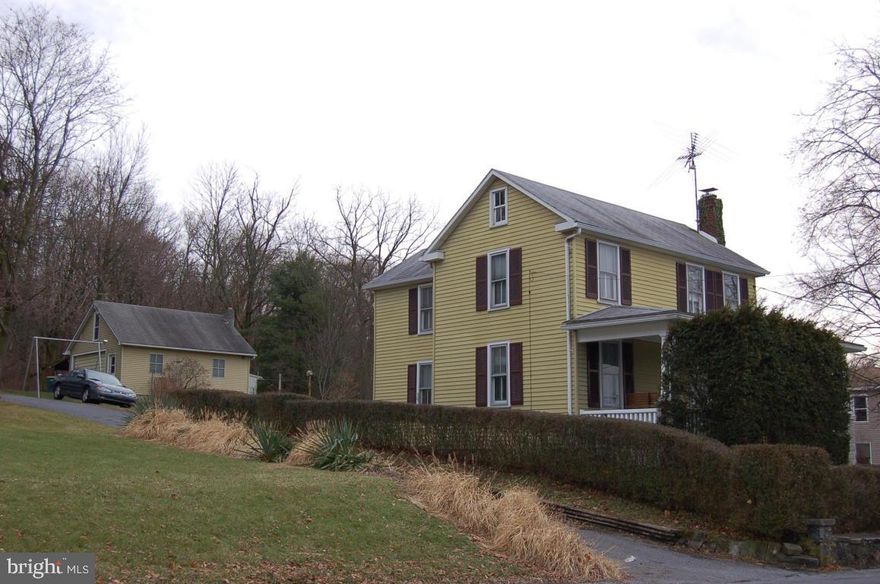 Country village home sits high on a hill nestled up against the mountain.