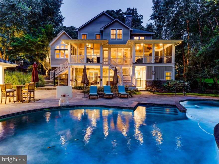 This sprawling Falls Church luxury estate property (only 15 mins to Amazon HQ2 and the D.C. line) is situated on a  private 2.3+ acre / 100,000+ sq ft lot and showcases a Craftsman-style cedar shake Farm House accentuated by immaculate outdoor & secluded spaces.  Entertain outdoors or treat yourself to a staycation at home and in style around the 800 sq ft heated pool (w/ new heater).  The expansive pool deck features a custom stone poolside cabana house and covered, outdoor kitchen & bar, each equipped with plasma TVs. Adjacent to the pool deck outside is a conditioned changing room / full bath complete with a custom-tiled shower for guests. Host an outdoor dinner party inside the massive addition designed in 2010 by Moser Architects: a  1,000 sq ft screened-in, three-season Trex Deck lounge and dining area that walks into the main home through three separate sets of glass French doors. The sprawling, fully-fenced grounds offer mature landscaping with a meticulous design plan and extensive man made drainage improvements.  The grounds include built-in, automated lighting and underground irrigation sprinkler systems for the many garden beds, flat open spaces to exercise and circuit train, and a fully-equipped playground.  An entrance drive-in with paddock fencing opens to a circular driveway with custom stone pavers and a handsome brick retaining wall for front-of-house parking.  The 3 car attached garage bay can house any combination of vehicles with an extended driveway pad outside for a boat, with direct access into the mudroom and laundry area.  Out front, the inviting, covered front porch opens into the two-story foyer with a cascading, curved staircase next to the front sitting parlor.  The interior of the home combines function (details such as wooden plantation shutters throughout & solid wood cabinetry built-ins) with design showcasing an open layout for a seamless transition between the Kitchen and Great Room, highlighted by a beautiful stone mantle gas fireplace and coffered, high ceilings.  The industrial Chef's Kitchen is softened by the one-of-a-kind wall of windows and vaulted ceiling constructed of cedar wood. The Kitchen features commercial-grade KitchenAid and Viking stainless appliances, including double ovens and a 4-burner gas cooktop w/ indoor grill and griddle all housed under a Best hood suspended above the width of the 3-seat center island.  The walk-in pantry is flanked by the dry bar for the espresso machine and a wet bar setup to showcase a variety of aperitifs.  Upstairs features 5 bedrooms. The Owner's Suite is a true getaway with a separate, graciously-sized sitting room complete with Bose sound system, gas fireplace and built-in cabinetry leading into the large Owner's bedroom,  substantial walk-in closets, and airy ensuite bathroom with 2 vanity areas and separate soaking tub. 3 completely renovated full bathrooms (2 ensuite) complement the secondary 4 bedrooms.  Bring the party downstairs to the Lower-Level, taken down to studs and completely rebuilt in 2010.  The Walkout Rec Room (to another outdoor entertaining dry space) features coffered, 8-foot ceilings to post up at the bar or on the sectional couch to enjoy a Home Theater experience via the integrated Crestron Whole House Speaker System.  Secondary rooms include an Exercise Studio / Game Room with guest half bath, a temperature-controlled Walk-In Wine Cellar (accommodating hundreds of bottles) and a Nanny / In-Law 6th Bedroom suite with a newly-built (2018) ensuite full bathroom.  There is no shortage of dry storage either, with a dedicated pool equipment and utility room accessed outside and a storage room inside.  Roof approximately 10 years old.  Centrally-located minutes to Rt 50/66/395/495 to access all points of Northern Virginia, Maryland and Washington, DC, this one-of-a-kind resort-like property is a rare opportunity to re-invent a new lifestyle at home with the conveniences of the city nearby.
