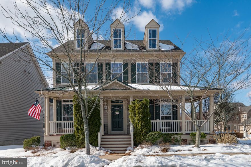 Welcome Home to this updated neo-traditional home with wraparound porch on a charming lot in desirable Brunswick Crossing. The moment you walk in from the welcoming porch, you will notice that the entire main level features solid, wide plank oak floors that really stand out. The formal living room or office is on your right and the formal dining room on the left, both flanked by decorative columns in the foyer. The dining room has direct access to the renovated kitchen, with a large island featuring quartz countertops and seating,  newer stainless steel appliances, as well as a dedicated breakfast table space. From there you have access to the backyard via a covered landing deck in the back of the home near the powder room and laundry room. The kitchen also opens up to the lovely family room with lots of windows. Upstairs, you will find a spacious primary suite with en-suite bath featuring heated floors and walk-in closet, as well as three additional bedrooms and full hall bath.  You will love the lower level, completely above grade with direct access to the beautiful patio, hot tub, large yard and two-car garage. This lower level functions like an in-law suite, with separate kitchenette, full bath and laundry in the utility/storage area. $3,000 carpet credit with acceptable offer!! You will absolutely love living here! All the amazing amenities and shopping that make Brunswick Crossing so unique and popular are easily walkable. Don't sleep on this one!