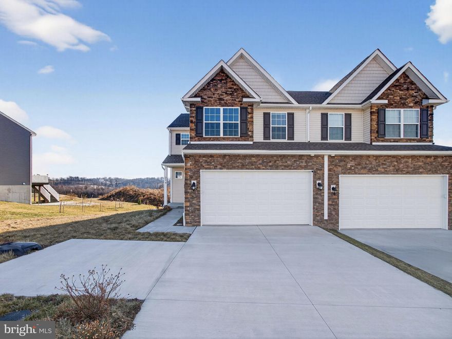 Why wait for new construction or pay full builder pricing when you can move right into this 2024-built home that still feels brand new! Offering over 1,800 square feet of thoughtfully designed living space, this home blends modern finishes with exceptional value. A private, angled entry with a covered porch welcomes you into the living room, with convenient access to the two-car garage and first floor powder room. The layout flows seamlessly into a separate dining room with a tray ceiling that opens to a stylish kitchen featuring dark maple cabinetry, quartz countertops, stainless steel appliances, a tile backsplash, and a center island with seating. The split staircase leads to a full hall bath with a linen closet, a laundry closet, and two generously sized bedrooms, each with large closets. The second level is completed by a spacious primary suite offering a sitting area, walk-in closet, and a private en-suite bath with a double vanity and walk-in shower. One of the standout features is the walk-out basement, ready to be finished. Perfect for additional living space, a home gym, office, entertainment area, or even an additional bedroom. This is a rare opportunity to own a nearly new home with built-in flexibility, functionality, and value.