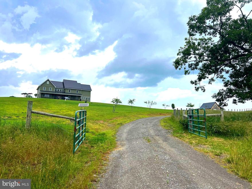 This custom built home sitting atop an eight acre grassy knoll boasts 64 windows affording breathtaking, panoramic views of distant mountains and rolling farmland!  Built in the middle of a six hundred acre, six generation farm, the insulated barn, with studio loft, allows you to have your own small farming operation on this unrestricted property! Great for an Airbnb for large  get-togethers or a perfect lodge /base for nearby outdoor adventures in Davis, Senecal Rocks, Smoke Hole and Canaan Valley for skiing, biking, fishing, kayaking, snowboarding and hiking! 
The home has Energy Star propane instant hot water systems and zoned HVAC for energy efficiency. 
Beautiful wood ceilings on main floor,  wood walls on lower floor (which is plumbed and ready for appliances for second kitchen) and custom stairway remind you of workmanship of days gone by.  The wrap around enclosed porch, as well as the sunroom with fireplace beckon you to enjoy the outdoors from within! 
Off the kitchen is a walk-in pantry. The  custom kitchen and bathroom cabinetry are second to none with custom lights and mirrors. The soaking tub allows you to view the surroundings of the outdoors from the third level of the home!
The full basement has roughed-in kitchen, a full bath and space for two or more bedrooms, at least. 
The barn is insulated and has water and electric. If you don't want animals, it's practically an entirely separate living space. Or use the barn for animals and the loft above for your studio or office!
You must see this beauty to appreciate all of the intricate details, down to the see thru fireplace between dining room and sunroom.. 
Get pre-qualified and make an appointment today to see this for yourself. It's not too late to plant your garden here and bring your chicken run!