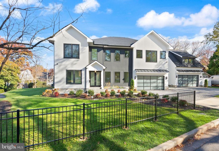 You have been waiting and here it is!!   Don't miss out!!   Location, Location, Location
Explore an exceptional contemporary residence in Lyon Park, Arlington—a newly constructed masterpiece featuring an elevator and a spacious 4-car garage. This luxurious home, spanning approximately 6,787 square feet, is perfectly situated on a picturesque 0.27-acre corner lot. With its two grand entrances, the home unfolds across three beautifully finished levels, including a bonus office/bedroom suite above a detached two-car garage. Inside, discover 8 bedrooms, 8 full baths, and 2 half baths, offering expansive and meticulously crafted living spaces. An elevator ensures effortless movement between all levels, while a state-of-the-art 2-zone HVAC system in the main house, plus a third zone above the garage, provides personalized climate control. The heart of this home is its exquisitely designed kitchen, seamlessly connecting to a welcoming family room with an elegant electric fireplace. This culinary space features an oversized Quartz island, dual sinks, a Miele dishwasher, a professional-grade 48-inch Wolf range with 6 burners and an infrared griddle, a 48-inch Subzero refrigerator, custom cabinet lighting, and a generous pantry. Adjacent, a butler’s pantry with a sink, beverage cooler, Quartz countertops, and custom lighting adds to the convenience and ambience. Step outside to a serene screened-in stone porch with a ceiling fan, overlooking the private, beautifully landscaped fenced backyard. Entertain effortlessly in the sophisticated dining room or work comfortably from the main level front bedroom/office with its own full bath. The luxurious primary suite upstairs boasts a spacious bedroom with an electric fireplace, coffee wet bar with a beverage cooler, a large, customized walk-in closet, a private balcony, and a lavish primary bath featuring a large glass-enclosed shower with dual shower heads and body sprays, dual vanities, a soaking tub, and a separate toilet room. Four additional private ensuite's and a well-equipped laundry room complete this level. The walk-up lower level is an entertainer’s paradise, featuring a signature Quartz bar with a beverage cooler, dishwasher, and glass shelving with custom lighting, a large recreation room, a bedroom with a full bath, and a media room. Outside, the professionally manicured grounds are enhanced by a black aluminum fencing in the front, PVC fencing in the back, permeable pavers driveway, an attached 2-car garage with epoxy flooring and an EV charger, and a detached 2-car garage with epoxy flooring and EV charger as well as an additional office/bedroom suite above this garage. This residence truly embodies contemporary elegance and sophistication. A block to Zitkala-Sa Park and near Clarendon's Metro, restaurants, shops, services, and nightlife.  Ring doorbell video cameras at entrances