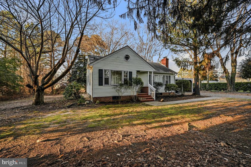Welcome to this delightful 1954 ranch home, ideally located on a corner lot in Dover—just minutes from shopping, restaurants, and everyday conveniences.  Mature trees and a peaceful neighborhood setting create an inviting sense of home, and a convenient carport keeps your vehicle protected from the elements. Inside, beautiful wood floors run throughout the main level, enhancing the home’s timeless character. The entry offers a coat closet and opens into a bright living room, featuring a large front window and a classic brick, wood-burning fireplace—perfect for cozy evenings and relaxed gatherings. Just beyond the living space, the dining area flows easily from both the living room and kitchen, offering a comfortable setting for daily meals or entertainment. The kitchen is functional and is a great canvas for future updates while maintaining its original charm. The main level includes three nicely sized bedrooms, with the primary bedroom offering two closets. Additional storage is thoughtfully placed with two hall closets, and a full hall bathroom completes the main floor. The full basement provides abundant space for storage, the laundry area, and future possibilities.  Existing plumbing offers the opportunity to finish an additional bathroom, adding convenience and long-term value. Step outside from the kitchen to enjoy a patio ideal for grilling and outdoor enjoyment. The backyard features a charming greenhouse for the plant lover, a storage shed, and manageable green space—perfect for gardening, relaxing, or simply enjoying the surroundings. With its classic ranch layout, thoughtful storage, and convenient location, this home offers comfort, character, and opportunity in a cozy setting. (Square footage is estimated; buyers are encouraged to verify.)