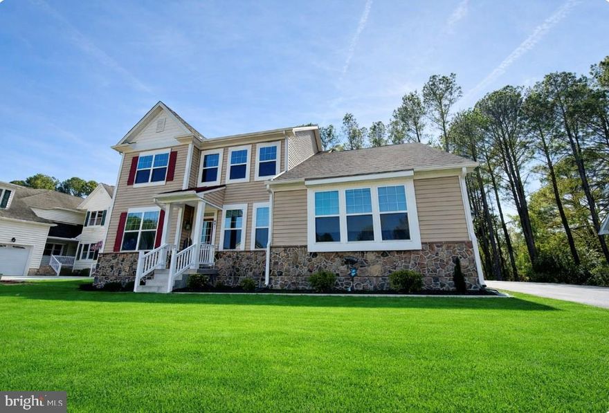 Welcome to 403 Bluewater Court, a stunning custom-built home located in the exclusive enclave of The Pointe within the premier waterfront community of Ocean Pines. Built in 2022 and offering approximately 2,665 square feet of beautifully designed living space, this 3-bedroom, 2.5-bath residence perfectly blends modern luxury with coastal charm. Situated on a high, elevated lot, the home welcomes you with a sun-drenched great room highlighted by a dramatic wall of windows, filling the space with natural light. A gas fireplace anchors the room, creating a warm and inviting setting for everyday living and entertaining. The gourmet kitchen is thoughtfully designed with upgraded countertops, a spacious island, and an inviting breakfast and conversation area—truly the heart of the home and a perfect gathering space for family and guests. Elegant finishes are found throughout, including rich hardwood flooring, ceramic tile, and a spa-inspired primary suite featuring a floor-to-ceiling tiled walk-in shower. The first-floor primary offers convenience and comfort, while the second-floor loft provides flexible space ideal for a media room, office, or additional lounge area. Well-appointed guest bedrooms, including en-suite accommodations, ensure privacy and comfort for visitors. Step outside to the rear deck overlooking the backyard—perfect for relaxing, dining, or entertaining. The home’s curb appeal is enhanced by beautifully maintained landscaping and mulch beds leading to the welcoming front porch. A side-load garage adds both function and aesthetic appeal. Living in Ocean Pines means enjoying an unmatched amenity-rich lifestyle. Residents have access to a private Ocean City Beach Club, a championship golf course designed by Robert Trent Jones Sr., & the popular Yacht Club & Marina offering waterfront dining/entertainment. The community also features a private police and fire department, walking and biking trails, scenic ponds, playgrounds, parks, and a convenient boat ramp for easy days on the water. Throughout the season, enjoy the vibrant farmers markets and community events that make Ocean Pines one of the most desirable coastal communities on the Eastern Shore. This is more than a home—it’s a lifestyle. Now is the Time to Invest in the Beach Lifestyle.