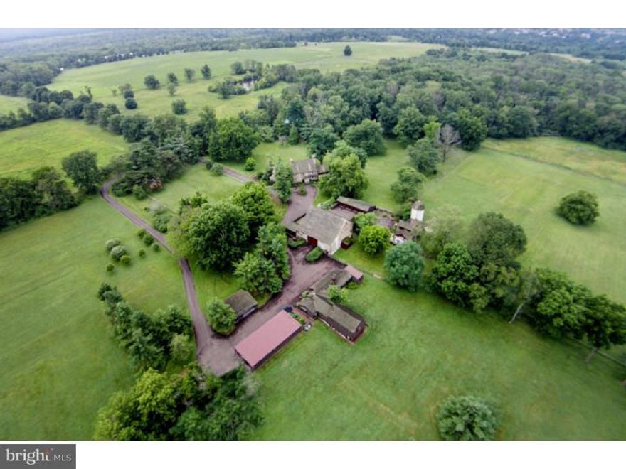 Introducing "Lane's End Farm": a rare opportunity to live on 18.57 private acres that are tucked away within hundreds of acres of preserved beauty. At the end of a long, tree-lined drive, Lane's End Farm presents the complete package: Newly renovated historic Manor House, Stone barn, Two cottages, Pool, Multiple garages and out-buildings; all within 234 acres of lush Nature Preserve. The Manor House underwent a detailed renovation, retaining the original details and charm throughout, such as random width floors, multiple fireplaces, deep window sills and original doors and hardware, while adding modern conveniences including updated kitchen & baths, new mudroom and new laundry. The masterfully designed kitchen offers plenty of space for everyday living and entertaining; designed around a large, marble center island, it features a commercial Wolf range with double ovens and beautiful custom hood, Subzero refrigerator, radiant heated floors, beamed ceiling and custom cabinets. The adjoining morning room with fireplace adds a delightful space for family meals. The light-filled family room offers panoramic views of the grounds and Preserve, brick floors, custom built-ins, large closets and doors to the garden and terrace. The dining room with beamed ceiling, fireplace and door to terrace is large enough for every gathering. A formal living room boasts dynamic views of the pond and grounds, and offers a relaxing retreat from the hustle and bustle of modern day life. The home office is just one more treasured space, with original details including a wonderful fireplace, beamed ceiling and other details, making this another wonderful spot to escape to. The second and third floor offers five generous sized bedrooms and four full baths, including a large master bedroom with fireplace, updated bath rich with detail, double vanity, double shower, claw foot tub and large adjoining closet and dressing area. This one-of-a-kind country lifestyle is just 40 minutes from Center City Philadelphia and is convenient to shopping, restaurants and entertainment.