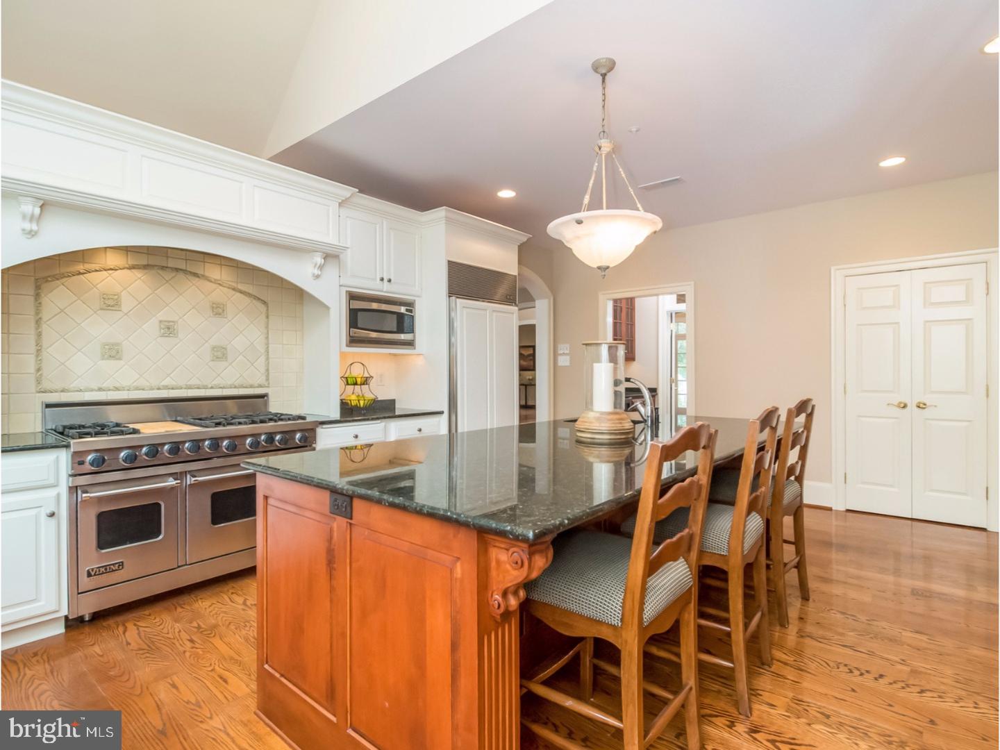 Magnificently appointed 5/6 bedroom stone colonial with handsome curb appeal in sought-after Harrison Estate. As you enter from the circular drive, you are welcomed by an airy two-story entrance hall with inlaid marble floors, wainscoting and dentil molding. The straight through hallway gives a sight line through French doors to designer pool, spa, terrace and level playing area. To the right, enter through graceful arched doorway to the living room w/grand cultured marble fireplace & rich hardwood floors. Study/office is just through glass French doors and features cherry paneling and built-in cabinetry. Enjoy the bright sunroom with three exposures including glass doors to patio. To the left of the entrance hall is the large formal dining room w/wainscoting and extra deep crown molding. Butlers pantry with beverage fridge leads to gourmet kitchen with white Kountry Kraft cabinets, granite countertops, stainless 6-burner Viking range, Miele dishwasher, Sub Zero refrigerator & oversized island with prep sink. Kitchen opens to sunny breakfast room with 2 pantries (one walk-in) and French doors to pool area. Adjacent is the family room with vaulted ceiling, custom millwork, built-in cabinetry with speaker system and gas fireplace. Main and back staircases, 2 half baths, mudroom, 4 car garage & generator complete this level. Second floor features a new master suite with natural shiplap tray ceiling, fireplace, and coffee bar with under mount beverage fridge. His & hers closets, new luxurious bath with dual vanities, jetted Jacuzzi tub, large shower with bench and rain shower head. Two additional en-suite bedrooms (one with window seat overlooking the pool) and two with shared bath. Convenient laundry & built-in homework/computer station. Entire third floor is a newly wood-floored bonus room space. Teen hangout? Craft room? Walk-out Lower Level features several areas for entertaining including TV viewing space with built-in speakers, pool table, gym, custom wet bar including 2 refrigerated beverage drawers & built-in microwave. State of the art sound distribution system and wiring by Main Line Sound & Video, everything controlled by iPad. The backyard is an oasis: pool, hot tub, flat playing field, extensive professional landscaping and mature trees. House features freshly painted areas, new carpeting, new solid core doors, new windows and exterior siding. All in amazing location convenient to both public & private schools such as Epis. Academy