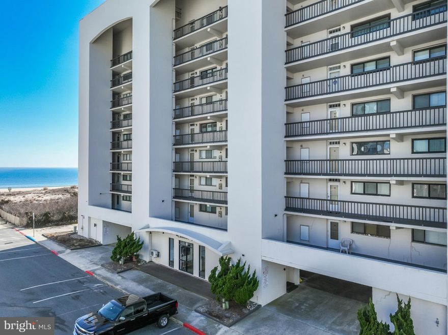 This exceptional 1100 sq ft, 2-bedroom, 2-bathroom corner condo is located in the serene and low-density area of North Ocean City, offering the perfect beach getaway. Relax and unwind while listening to the soothing sounds of the ocean from your expansive 52ft wrap-around balcony, which provides breathtaking views of the ocean from the dining room, living room, kitchen, and master bedroom. Surrounded by an oasis of tranquility, this condo boasts luxurious finishes and features, including 48" custom cabinetry, quartz countertops, and stainless steel appliances in the kitchen. Crown molding, tile floors, and a newer heating system and water heater add to the home’s appeal. The master bedroom is a peaceful retreat, offering balcony access and an ensuite bathroom with a tiled oversized shower, comfort-height vanity, and tile floors. The spacious second bedroom accommodates two queen beds and features a large closet. Adjacent to this bedroom, the guest bathroom includes a walk-in tiled shower and comfort-height vanity. Conveniently located near shopping, restaurants, entertainment, and North Side Park, the community also offers outdoor tennis courts, an inground pool, storage, and covered parking. Enjoy the spectacular Fourth of July fireworks right from your wrap-around deck. If you’re looking for the ideal beach escape, this condo is the perfect fit!