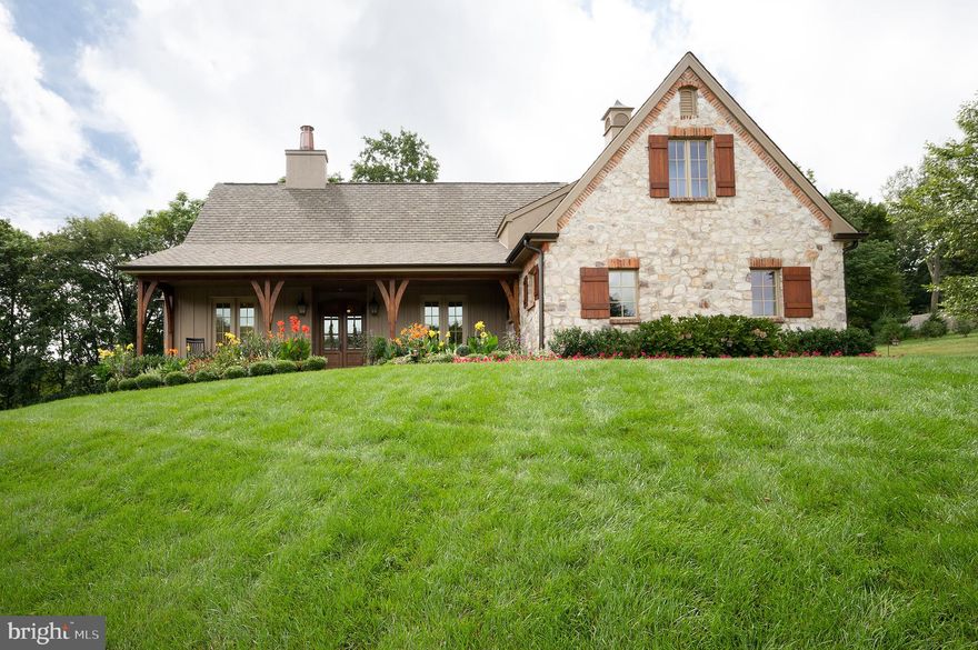Located on a prime lot in Wagoner's Row, this beautiful residence enjoys an abundance of open vistas, woods and pond views. Created with total relaxation in mind, the architecture, landscaping, and interior design are seamlessly fused together. Exposed beams and volume great room ceilings are light and welcoming, the airy, open-flowing great room linking flawlessly with a modern kitchen. On the first floor the residence comprises an entry foyer with custom appointed hardwood flooring, leading to the open great room, chef kitchen with center island & built-in appliances, separate breakfast room, laundry and main level primary suite with private bath, custom fit-out walk in closet and sitting room. Additional main level features include a 2nd bedroom, main bath, laundry and two-car side entry garage. The upper level includes a 2nd primary suite with a well-appointed private bath, and two walk-in closets. Exceptional outdoor entertaining from the covered porch with roll down electronic screens leading to the open terrace appointed with an outdoor kitchen, overlooking the private-well landscaped setting. Additional highlights include a custom designed stone/brick fireplace wall in the great room, Vantage house automation system, electronic shades, heated flooring in the primary suites, brick herringbone walkways and a full un-finished lower level.