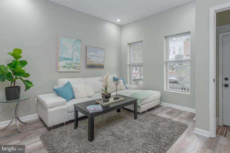 Nicely updated porch-front home ready for a new owner. First floor features a large living room with exposed brick, all new flooring throughout, separate dining room, and a trendy kitchen with blue cabinets, granite counters, and stainless steel appliances. Second floor is spacious with three large bedrooms and two full bathrooms, all new carpeting and new paint throughout. Lower level is perfect for storage. Ground rent to be verified by the buyers.