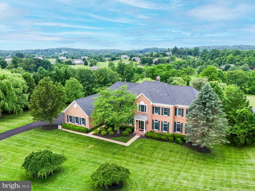 The breathtaking, tree-lined entry road to the rolling hillsides and private enclaves draw you home to the peace and tranquility of this prestigious and private community. Newly refreshed and renovated top to bottom with hand selected finishes and beautiful neutral colors this, feels like a brand new, luxury home with over 7,600 finished sq feet. Sitting proudly among the exquisite estate homes of Shenstone Farm with rolling landscapes and sweeping views of the Leesburg countryside.

Crossing the threshold into the magnificent two story foyer the curved staircase is a welcoming statement of elegance.  A beautiful blend of openness and artfully designed living spaces offer versatility and grandeur at every turn. All new light fixtures and chandeliers add custom, designer touches throughout the house. Refinished oak hardwoods throughout the main level and new carpeting on both the upper and lower levels create a fresh backdrop for any style and décor. The enormous great room surrounded by windows with a raised brick hearth fireplace showcases the spectacular views of this stately home. Sweeping hills and vales covered in blankets of snow or adorned by blossoming Dogwoods, Cherry blossoms and spring flowers create a canvas for every season. Just off the great room the corner office with bay window and built in bookshelves makes a dream home-office space with views across the treetops. Around the corner the sunlit conservatory offers a quiet and secluded space for music or reading, afternoon tea or a peaceful retreat from the world.

The huge picture window over the kitchen sink is only one of the bright features of this newly renovated gourmet space. A wall of windows and sliding glass doors offer lightness and sunshine from every angle. Brand-new quartz countertops and custom tile backsplash complement the beautiful, rich cabinetry. All new appliances including double wall ovens and LG Smart fridge.  The mudroom, side-porch entry into the laundry room and kitchen creates ease of access and flow. Main floor bedroom and full bath just off the kitchen and garage offers flex space for in-law or au-pair suite, additional home office, exercise room or secluded guest suite.  

The renovated primary bathroom is a sanctuary of softness and light, well appointed with brushed gold and antiqued bronze finishing touches, walk-in custom tile shower with double shower heads. Luxurious soaking tub, speckled quartz countertops and oversized tile flooring are the epitome of understated elegance. Four additional full bathrooms upstairs have all been renovated with new vanities, light fixtures, designer mirrors, faucets, hardware, toilets & shower doors.  Artful shadow boxing, crown & chair rail molding elevate the spacious guest suites, each with their own en suite full bathroom and walk-in closet(s).

Downstairs, the expansive, walkout basement with French doors and full sized windows overlooks the sprawling rear gardens and natural stone patio nestled by columns and carriage lights, built-in stainless gas grill with storage and warming drawers. All new recessed lighting throughout the lower level brightens this exceptional entertaining space complete with granite wet bar with counter seating, raised brick hearth fireplace and room for full sized billiards and other game tables. An oversized media room with brand new, plush carpeting, a 7th full bathroom and loads of unfinished space offer potential for a 7th bedroom, a home gym, storage areas or additional entertainment spaces. Freshly painted, Landscaped, power washed windows and driveway freshly sealed; Every surface has been upgraded and refreshed with newness and style. Roof replaced 2022. Just around the corner from downtown Historic Leesburg, Ida Lee Rec Center and the Loudoun County Fairgrounds, located just minutes from shopping, restaurants, the outlets, wineries & fine dining, where hunt and wine culture abound.