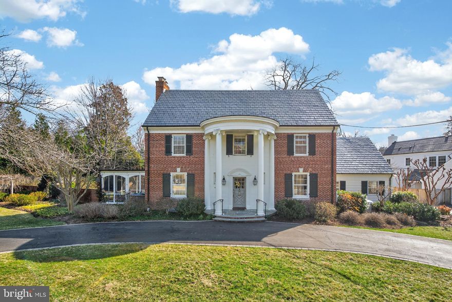 Nestled in the heart of Kenwood and cherished by two generations of the same family for more than 75 years, this classic four-level, six-bedroom, four- full bathroom, two-half bath brick Colonial offers timeless character, generous space, and exceptional long-term potential in one of the area’s most sought-after neighborhoods.

Set on a beautifully level lot, the home is framed by a circular front drive and a convenient side driveway, leading to lush lawns, mature gardens, and an expansive flagstone terrace—perfect for outdoor entertaining. Stately columns highlight the welcoming front entrance and complement the home’s handsome brick façade.

Inside, a gracious entry hall opens to elegant, light-filled living spaces, including a formal living room with a wood-burning fireplace, a spacious dining room ideal for gatherings, and a charming study with built-in shelving. The large kitchen flows into a dramatic family room addition featuring a soaring ceiling, breakfast area, built-in cabinetry, and a second wood-burning fireplace—creating a warm and inviting hub for everyday living.

A recently converted one-car garage now serves as a bright art studio, easily adaptable as a home office, creative space, or additional flex room.

Upstairs, the second level offers four bedrooms and two full baths, including a primary suite with exciting potential to expand—allowing space for a larger spa-like bathroom and enhanced closet storage. The third floor adds two additional spacious bedrooms, a full bath, and convenient attic storage.

The lower level features an exterior stairwell, a recreation room, full bath, bonus room, and utility space—ideal for guests, hobbies, or future customization.

Move-in ready and filled with opportunity for thoughtful updates over time, this special property offers the rare chance to create your dream home while enjoying the enduring appeal and value of the Kenwood community.