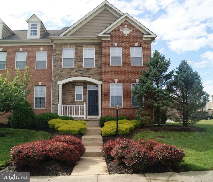 Former Model, 3 Level End Unit Townhouse with Stone and Brick Front,  Full Brick Side and Extensive Landscaping! The  adjacent common area lot  will never be developed!  This 3 bedroom, 3.5 bath, Open Concept home has all wood floors on the main level and a fully finished basement with Tile Flooring. The Home has extensive crown moulding, chair rail and wainscot. The Kitchen has Granite Counter Tops, Cherry Cabinets, Stainless Steel Appliances and a Deck leading to the 2 car Detached Garage!  House has been completely repainted in the last 90 days, carpets cleaned and  ready for you to make it your own!