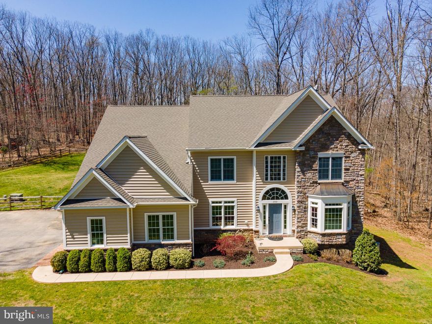 Come home to luxury, privacy and the perfect space for every occasion! Stunning colonial situated on 4.96 acres. Custom designer touches throughout!  Main level offers open floor plan and plenty of natural light. The Kitchen offers Jenn Air SS appliances, granite countertops, tile backsplash, glazed cabinets, butlers pantry*Lovely family room with coffered ceilings and pellet stove. Home office and Dual staircase! Head upstairs to find three additional bedrooms, three full bathrooms and plenty of storage space. The finished basement boasts a large recreation room with a wet bar, media room and full bath. The large backyard is an entertainer’s delight with its large paver patio, In ground salt water pool,stamped concrete, stone fireplace, built in grill, fence*New flooring, laminate, wood and carpet*Updated Lighting fixtures*Coffered ceiling*Recessed lighting*Remodeled finished basement with full bath, Bar, Media Room, Huge Storage Area*New well pump with variable speed well pump (2020)*Tankless water heater*
HVAC – Trane 20 seer heat pumps, 96.9% 2 stage gas furnaces (propane) – 2 units (2018)*Generator*
Anderson 400 windows and doors (2014)*Primary bath remodeled
There is simply no detail left out and nothing to compare with this spectacular entertainer's delight that is sure to invite gatherings large and small. This property is immaculate, well-cared for, and ready for new owners. Welcome home!