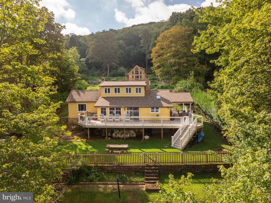 Nestled on 100+/- feet of pristine Deep Creek Lake shoreline, this 6-bedroom, 3-bathroom cottage perfectly blends classic lakeside charm with modern comfort. Featuring a Type A dock, wood-burning stone fireplace, hardwood floors, tile bathrooms, and a remodeled kitchen with granite countertops and Bosch appliances, the home is designed for both relaxation and entertaining. Thoughtful custom touches throughout highlight the seller’s careful upgrades, including updated electrical, new heating and cooling, renovated bathrooms, and a new roof. A partially covered wraparound deck offers unobstructed lake views, making it the ideal spot for morning coffee or evening sunsets. Perfectly situated in a prime Deep Creek Lake location, this property is just minutes from restaurants, shopping, Wisp Resort, and state parks—making it an ideal retreat or year-round home that truly captures the essence of lakeside living. Call today to schedule your private showing!