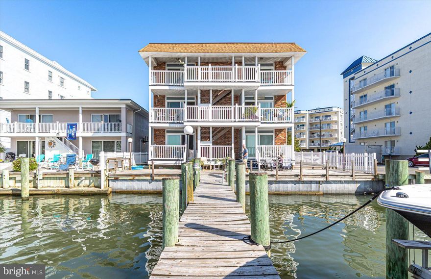 Welcome to your slice of waterfront paradise! This recently renovated two-bedroom bayfront condo offers a blend of modern luxury and tranquil coastal living. Featuring a spacious, open-concept family room that overlooks the shimmering bay, this home is perfect for entertaining family and friends. Enjoy breathtaking sunsets and watch the boats come in during the White Marlin weigh-ins from the comfort of your private deck—truly a front-row seat to the action. The chef in your family will delight in the gourmet kitchen, which boasts quartz countertops, a stylish tile backsplash, stainless steel appliances, kraftmade cabinets, an undermount sink, upgraded lighting, and a convenient beverage center. The generously-sized primary bedroom includes a walk-in closet and a glass slider leading to a private balcony—ideal for morning coffee or evening relaxation. The remodeled bath is a sanctuary with a custom spa shower featuring a glass, soft-close door. The second bedroom is spacious as well for family and friends.  Tech enthusiasts will appreciate the smart home features, including the Lutron Caseta Smart Home Hub, compatible with Siri, Alexa, or Google for seamless remote control of your home’s functions.
Additional updates include new windows, hardy board siding, updated balcony railings, a new roof (2020), refurbished balconies (2023), new balcony sliders, and plush carpet on balconies and stairs. The condo also features a convenient fish cutting station for the avid angler. Situated close to the beach, boardwalk, restaurants, and shopping, this home also includes a boat slip and a PWC slip—offering all the amenities you need for the ultimate bayfront lifestyle. Don’t miss out—schedule your showing today and make this dream home yours! Please see documents for the list of upgrades that have been made.