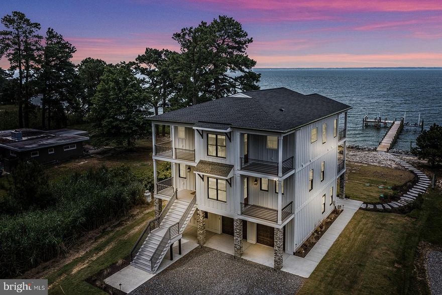 Absolutely stunning newly built and completely furnished beach house on Windmill Point with unobstructed vistas across the Rappahannock River and Chesapeake Bay. Builder's own home designed and constructed with a very upscale finish. The photos tell it all! There are three levels. The upper level features a large great room with kitchen and dining area, vaulted ceilings, large porch both covered and uncovered, a second covered porch for grilling, a powder room and large ensuite bedroom with private covered porch. The main level boasts three more ensuite bedrooms including the primary with amazing bath and walk in closet and a huge private covered porch The lower level is where you will find an awesome rec room with Prince professional grade ping pong table as well as the fifth ensuite bedroom. The new pier boasts a 15,000 lb lift as well as an 8,000 lb lift. There are four HVAC zones to the house, irrigation, low voltage lighting from the pier to the landscaping around the home. The home is beautiful and not to be missed. Complete feature sheet available.