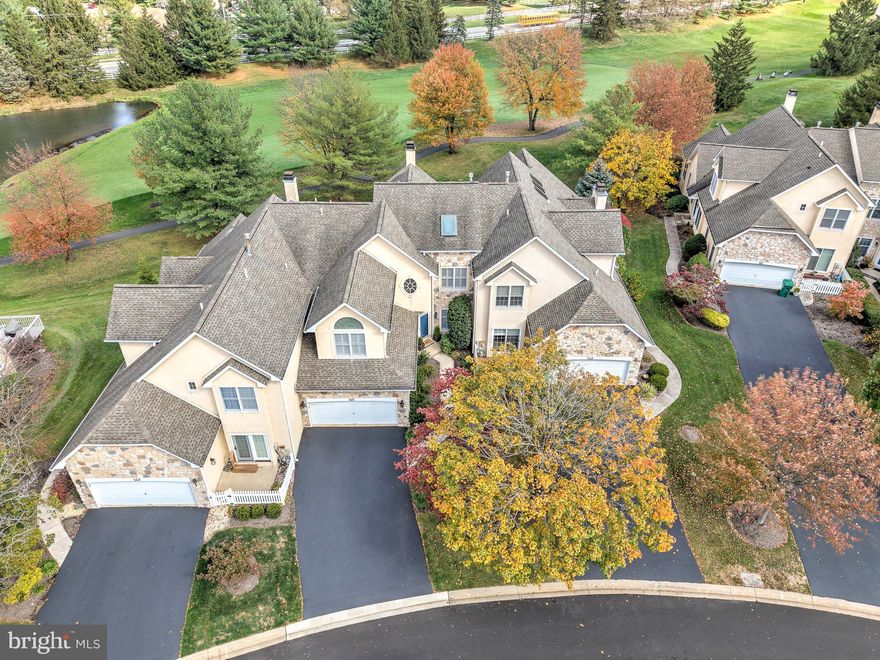 This lovely carriage home in Blue Bell Country Club offers the perfect blend of elegance and warmth with lovely views of the second fairway and pond. The home's attractive front entrance with its landscaping is welcoming and inviting. Upon entering the home, you will immediately appreciate its luxurious features beginning with the two story, light filled foyer. Hardwood flooring throughout the main floor and stairway to the second level have been refinished with Bona Nordic Seal to create a more contemporary and sophisticated effect and that is easy to maintain. There is a formal dining room accentuated with crown moulding and a chair rail that is spacious enough to host family and friends for those special gatherings. It is just off the foyer and has easy access to the kitchen.  A living room with cathedral ceiling and two story window wall that affords views of the golf course and pond is a wonderful space for entertaining or just relaxing. The heart of the main floor is the magnificent gourmet kitchen, dining area and family room which is situated in an open concept space at the rear of the home. Here you can appreciate golf course and pond views as well as a cozy fireplace that can be enjoyed from the kitchen, dining area, and family room. The kitchen features gorgeous granite countertops, beautiful cabinetry, gas stove & oven, microwave, Bosch dishwasher, and pantry.  From the family room and dining area, step out onto the deck to enjoy the scenery of the golf course and pond while relaxing or entertaining in this spacious but cozy outdoor area. Completing the main level of the home is a freshly painted powder room and a laundry room with a utility sink. On the second level is the primary bedroom suite with double walk-in closets and bathroom with double sinks, soaking tub, and stall shower.  Two additional spacious bedrooms, one with a walk-in closet, and a hall bathroom that  is also accessed directly from one of the bedrooms round out the second level.  An added feature of this home is the third floor loft that can serve as a den, office, exercise space, or guest bedroom. Both upper floors boast new carpeting. There is also a large unfinished basement that currently provides ample storage and could be finished for even more living space.  A two-car garage, double driveway, and guest spaces offer plenty of parking options for you and your guests.   As a resident of the vibrant Blue Bell Country Club community, you will have access to walking paths, bike lanes, pickleball, tennis and basketball courts, tot lot/playground, fitness center, pool and community center. Various organized activities and food truck opportunities are scheduled throughout the year. There is also the opportunity to become a member of the country club that is located on the property and offers various membership levels.  In addition, the location is convenient to shopping, outstanding restaurants, regional rail, and major thoroughfares. An amazing home and lifestyle await you, so don’t hesitate to schedule a showing!