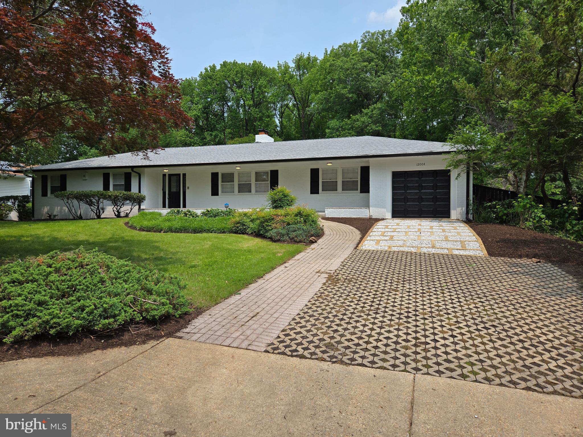 Incredible rambler with detached 2-car garage situated across three lots totaling 1.21 acres in the serene Holmehurst area of Bowie, MD. The property is nestled on a quiet tree-lined street providing a luxurious country manor living experience but located within the suburbs near major transportation routes and shopping centers. The home and detached garage have undergone total renovation providing exciting living and working spaces with abundant amenities. The house boasts 6 bedrooms and 4 full baths. The main floor has beautiful hardwood throughout; 4 bedrooms; 3 full baths; a formal dining room, living room; a large kitchen containing a fireplace and space for a breakfast area. The lower level has a huge rec room with a fireplace and a bar ideal for entertaining. There are two large bedrooms and a full bath and abundant storage space. There is even a working sauna! The rec room opens unto a patio which leads to the inground pool and pool house. Across the yard is the 2-car garage which contains a large specially designed air-conditioned room which can be used for a studio, office, exercise room…the uses are limitless. Although this 2-car garage is detached, the main house has an attached 1-car garage which opens into a mud/laundry room right off the kitchen on the main level of the house. This property is beautiful and must be seen to be appreciated.