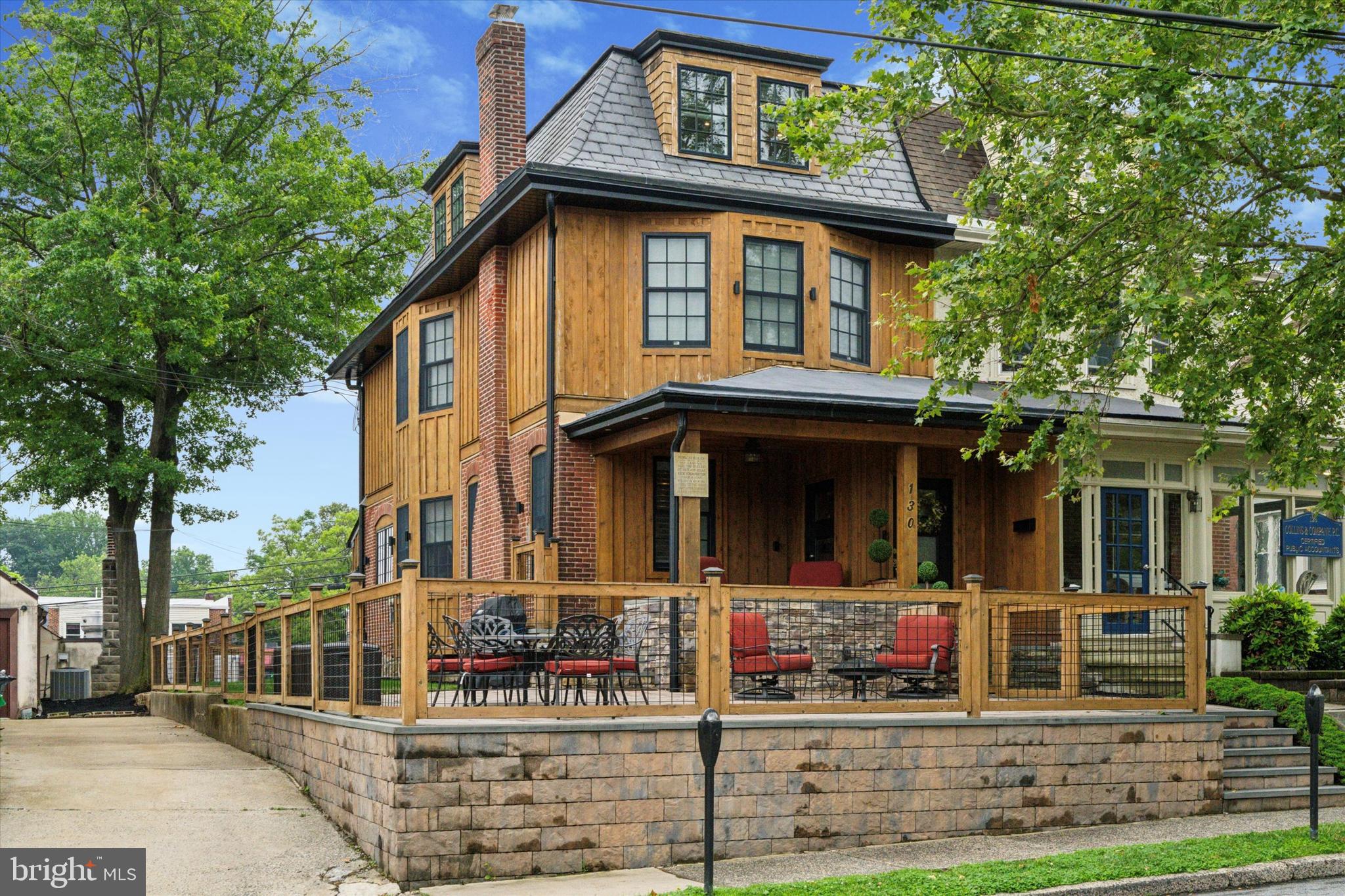 Meticulously transformed by its current owners in 2017–2018, this modern rustic farmhouse-style home combines timeless charm with thoughtful upgrades, making it essentially just 7 years young—with property taxes still under $7,000!
Love the idea of living in the heart of downtown Media—where Dining Under the Stars, parades, festivals, and the farmer’s market are all just steps from your door? This home gives you front-row access to it all, plus an incredible wraparound outdoor space for entertaining and a private 6-car driveway to solve all your parking needs.
What immediately catches the eye is the striking exterior—a blend of historic character and custom modern craftsmanship. The rich natural wood board-and-batten siding, classic red brick, black-trimmed windows, and dramatic slate-style mansard roof create unforgettable curb appeal. A covered front porch and expansive wraparound patio, elevated with a stone retaining wall and framed in wood-and-wire railing, provide the perfect setting to relax and soak in the energy of Everybody’s Hometown.
Inside, the main level features an open-concept layout that’s warm, stylish, and filled with personality. Hand-scraped hardwood floors run throughout, complemented by exposed brick and wood beams. The living room is anchored by a floor-to-ceiling stone fireplace and flooded with natural light from oversized windows with plantation shutters.
The dining area is framed by a stunning curved wall of windows—perfect for intimate dinners or lively gatherings. At the heart of the home is a chef’s dream kitchen with a large center island (seating on both sides), granite countertops, custom cabinetry, open shelving, and high-end Thermador stainless steel appliances including a commercial-grade range hood. The exposed brick adds a rustic yet refined touch that ties the space together beautifully.
Just beyond, the butler’s pantry includes a large farmhouse sink, floating shelves for barware or décor, and a built-in mini bar—ideal for entertaining. A stylish powder room, access to the basement, and rear entry to the yard and driveway complete the main floor.
Upstairs, barn-style doors open to a bright and spacious primary suite with hardwood flooring, a cozy sitting area or office nook, a large walk-in closet, and a spa-inspired en-suite bathroom. Enjoy dual granite vanities, natural wood cabinetry, and a walk-in shower with floor-to-ceiling tile, rainfall showerhead, and stone-tiled flooring. The laundry room is conveniently located on this level as well.
The third floor features three additional bedrooms—all with original hardwood floors—and a full hall bathroom with a tub/shower combo and tasteful finishes.
This home offers unbeatable walkability paired with comfort, charm, and impressive finishes at every turn. Don’t miss your chance to own one of the most distinctive homes in downtown Media—this is the lifestyle you’ve been waiting for.
