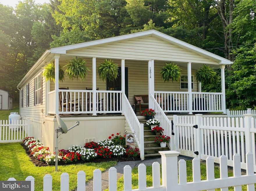 Dreamed of life behind a white picket fence? This one-story, 3 bedroom / 2 bathroom home in a peaceful rural setting with tree-lined views, might be the one.

Step onto the welcoming front porch—perfect for evenings with a glass of tea and a good book—and enjoy the enclosed front yard with white vinyl fencing and a handy storage shed. Inside, an open floor plan connects the living, dining and kitchen areas, all finished with newly installed luxury vinyl plank flooring. Cozy up by the living room fireplace beneath soaring cathedral ceilings. Practical touches include main-level laundry, a ramp to the side exterior door, a whole-house generator, and a primary ensuite with a handicap tub.

Comfort, convenience, and charm—this home has so much to offer. Call today to schedule your tour!!!