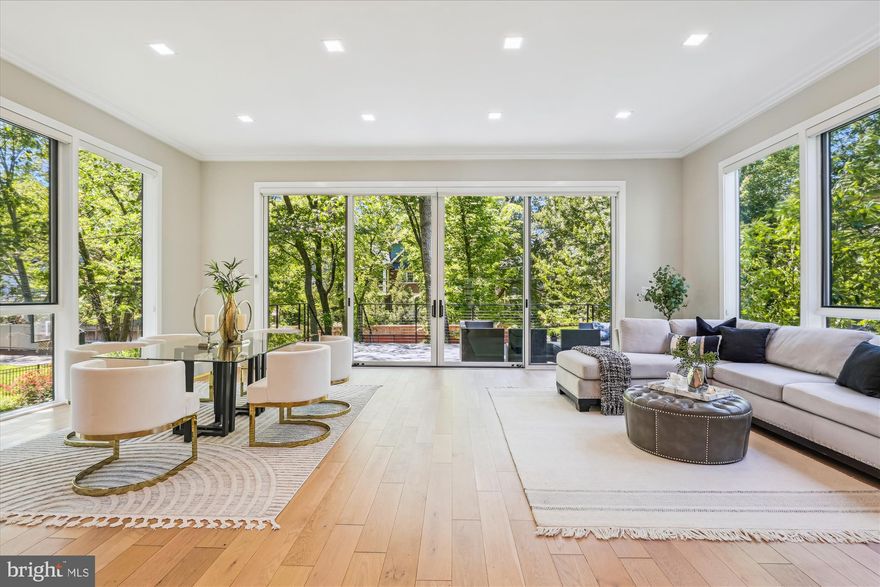 Welcome to 5706 Nevada Avenue Northwest in the highly desirable Chevy Chase neighborhood of Washington, DC. This expansive residence, fully renovated in 2018, boasts 6,258 square feet of meticulously crafted living space and offers an envy-worthy blend of modern style and abundance. Enjoy a welcoming lofted foyer accentuated by a striking stone fireplace. The gourmet kitchen is truly a chef’s dream featuring Viking appliances and a smartly placed oversized quartz kitchen island with ample bar seating. Adding to the kitchen area is a distinguished dining space which comfortably accommodates any large gathering. The impressive floor to ceiling windows open to a TREX back patio and a well-manicured lawn for summer parties. The second floor offers a dream-worthy primary suite with south-facing views; the king-sized space offers a walk-in closet as well as a modern bathroom featuring two waterfall showers, luxurious soaking tub and expansive double vanity. There is also an informal sitting area leading to two generously sized bedrooms. A well-placed guest bathroom is beautifully finished in marble. Continuing to the third level, one can enjoy a thoughtful entertaining space including a full wet bar and an impressive wall of windows that lead to the second private outdoor balcony. An additional well-sized bedroom with multiple closets provides a perfect escape for visiting guests. The finished basement completes this intentionally designed home. This level offers a quiet bedroom and bathroom, tucked away from the flexible entertaining space. Expanding upon an inviting wet bar, the space provides an opportunity to gather for a game night, enjoy cocktails or host the neighborhood movie screening. The basement is truly its own dedicated retreat. Just a short walk to Lafayette elementary school and Broad Branch Market, the neighborhood prides itself on its quaintness and ample greenery. The Chevy Chase community offers superior proximity to downtown DC and into suburban Maryland. Restaurants and shopping are minutes away along the tree-lined streets of upper Northwest.