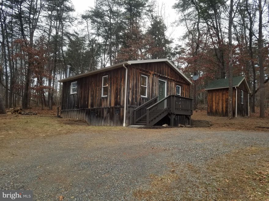Looking for that little city escape to the mountains or get the hell out of Dodge property? This may be it! Rustic on the outside, tasteful and cozy on the inside...come add your personal decorating touches to this charming cabin in the wooded mountains of West Virginia. ...Enjoy eating outside through the summer on the cute deck and nights around the fire pit! Surrounded in woods and wildlife this cabin on 3 1/2 acres can be your escape!