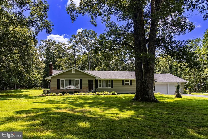 This spacious rancher is nestled on a gorgeous two-acre lot, offering plenty of room to relax, play, and enjoy the outdoors. The home has been beautifully cared for over the years and has great bones, with a warm, welcoming feel throughout. While the finishes are a little dated, it’s clean, solid, and ready for your personal touch to make it your own. The combination of peaceful surroundings and a well-kept home makes this a special place with so much potential. This home offers three generous sized bedrooms and two full bathrooms, one being a primary ensuite. Through the kitchen it'll lead you to a sunroom and bonus/flex room with a brick fireplace that leads to the private deck. Beyond the two car attached garage sits a bonus detached one car garage would make for the perfect work shed.