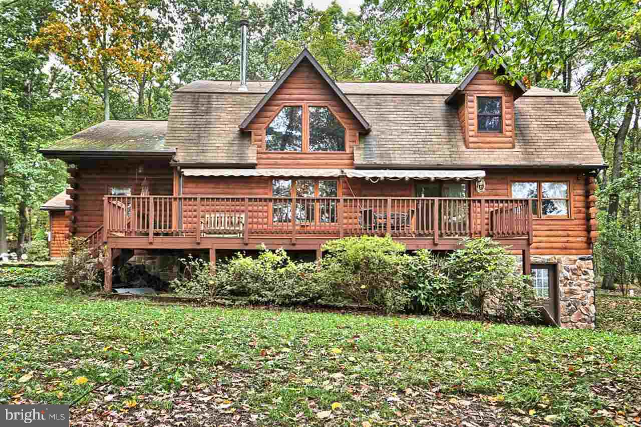 This private, secluded Custom Log home sits nestled atop a beautiful hill over looking Powells Valley! Enjoy all nature as deer & turkey regularly come across your yard. Lg wooded 10 acre lot in Clean & Green, w/ 2 car oversized garage w/workshop, large barn, and outdoor shed. Home has a 1st Flr Master Bd Suite w/bath, loft, separate laundry room, open cathedral ceiling in great room w/ pellet stove, beautiful HW floors, 2 decks w/ French doors. See your agent for Specific Showing & Offer Instructions!