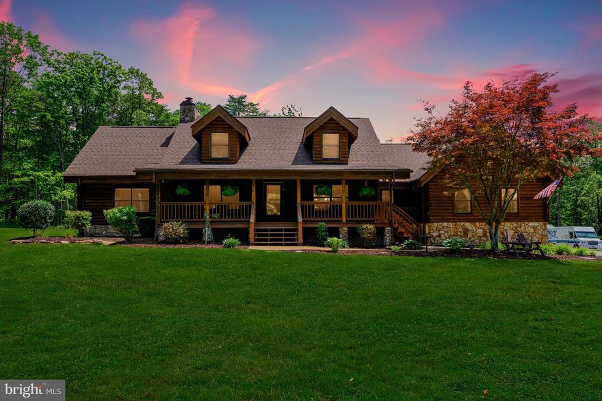 Nestled in the woods, this 3,000+ sq. ft. log home on 7 acres is private & offers quality construction & upgrades galore including a beautiful kitchen with New Cabinets, Stainless Appliances, Granite Counter-tops, Hardwood Floors, Exposed Beams, Vaulted Ceilings, Main-Level Master Bedroom & Tons of room to spread out in the Enormous Family Room.  Never run out of hot water with the whole house instant-on hot water system.  The entire home was recently power-washed and stained and the crawlspace has just been conditioned.  Come relax in this amazing home.  You will not be disappointed.