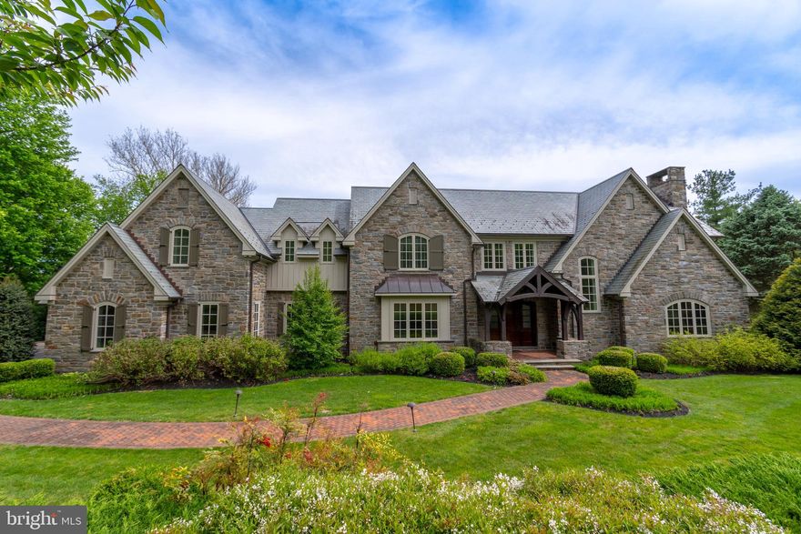 Introducing this elegant stone estate situated on almost 2 acres of beautifully manicured grounds. This stunning home is luxury at its finest offering every amenity & feature you could ever want. The custom home greets you w/stone pillars, private driveway,  stone walls accenting the gardens, paver patio walkway to the front entrance & beautiful slate roof. This luxurious home features h/w floors throughout, sunlit rooms w/natural light, coffered ceilings, wainscoting, recessed lighting, over-sized arch doorways, beautiful woodwork details & trim. Enter through a covered porch to a grand Foyer that truly sets the tone for this charismatic home. The 2 story Foyer features h/w floors, crown molding & wainscoting. The Foyer opens to a large sunken, sunlit Family Room w/impressive views of the picturesque grounds & patio. The Family Room features a fireplace w/14 foot stone wall & wood mantel that is sure to be a focal point on those cold wintery nights. This room has a coffered ceiling & double door opening to the large flagstone  patio. Enter the Kitchen through an over-sized arch doorway flanked by glass walls from the Family Room. The show stopping Kitchen is truly unforgettable w/custom cabinets, fridge & full size freezer, wolf oven, gas range, granite counters, over-sized island w/cabinetry & sunlit Breakfast Room. The Breakfast Room is surrounded by windows allowing natural light to pour in & access to the large patio. The patio has a built-in grill & fridge.  Enjoy the beautiful views of the in-ground pool while entertaining on the Patio or barbecuing. The formal Dining Room has a coffered ceiling, wainscoting & access to a spacious Butler's Pantry. The Butler's Pantry has granite counters, sink, ice maker, wine fridge, glass cabinets & drawers. This layout is perfect for entertaining, whether it is small intimate gatherings or large holiday parties. Walk down the hallway to a large Den w/crown molding, door access to the patio & walk-in closet. Across the hall is an extraordinary Study w/ double door arch entrance, wood walls, gas fireplace w/beautiful wood details & mantel, herringbone pattern h/w floors, coffered ceiling, custom built-ins & custom wood ladder. Completing this room is a large window seat overlooking the front gardens. On those rainy days, park your car in the 3 Car Attached Garage & access the home through the Mud Room. The Mud Room features custom cubbies w/storage. The built-in bench is perfect to use when you need to take off your winter attire & boots. This room w/its abundance of storage & garage accessibility is a must have for any family. The Mud Room also gives access to the covered Breezeway w/stone walkway that leads to a 2 Car Detached Garage w/ Bonus Room & half Bath. In the main house, walk up the Foyer staircase or back staircase to reach the Upper Level. The spacious Master Bedroom Suite features a tray ceiling, h/w floors & fireplace flanked by windows. The Master Bath will transport you to a spa like atmosphere w/tile floor & custom inlay, 2 sinks w/custom cabinets &  granite counters, a sunken jacuzzi surrounded by granite, water closet & large tile stall shower w/bench. The Master Bath also gives access to an exquisite Master Walk-In Closet w/custom built-ins, double door closet & large island w/drawers & granite counter. This Level also features a second Master Bedroom w/Sitting Room & full Bath, 3 additional Bedrooms that all feature ceiling fans & spacious walk-in closets w/built-ins, 2 full Baths, hall linen closet & Laundry Room w/sink & built-in shelves w/large counter perfect for folding laundry.  This home is truly a one of a kind home. Do not miss this opportunity to own a home in the great neighborhood of Pennock Woods that has so much to offer in schools, restaurants parks and the ability to walk to Meadowbrook Train Station. This home was designed for year round entertaining with modern luxuries and old world charm! See attached for description of Finished Lower Level!