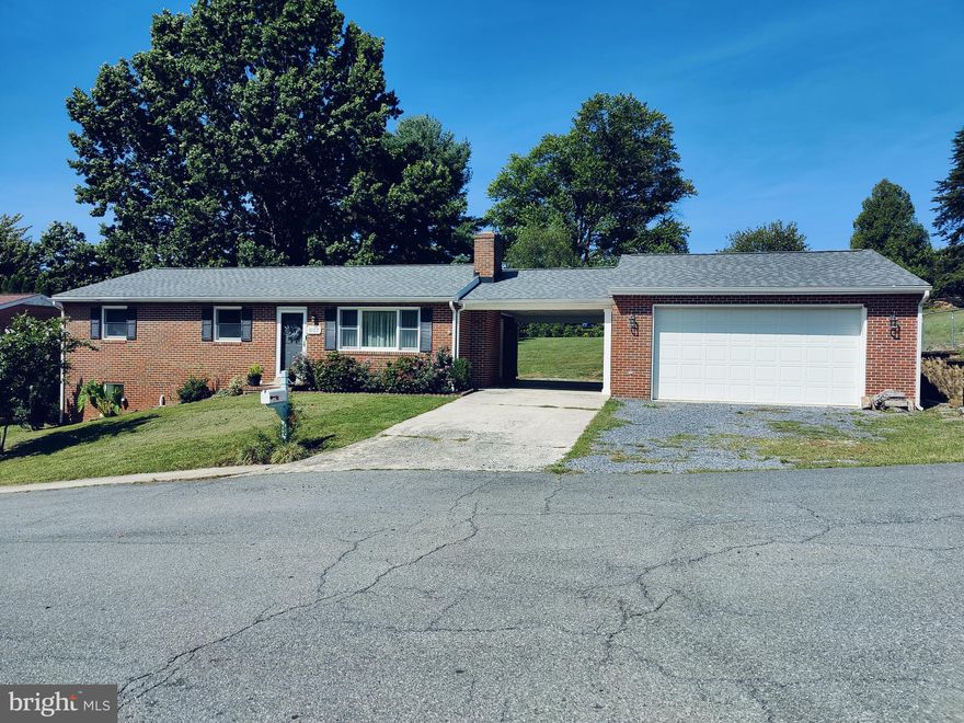 Full brick rancher on double lot; nearly half acre, with an oversized two car garage & carport! Walk into your spacious living room with original oak hardwood flooring, crown molding. Two wood burning fireplaces, upper level FP has mantel & ceramic tile accents: lower-level FP, brick surround.  Walk- out door to the carport from the kitchen which also features plenty of counter space, and a nice sized pantry closet. The spacious dining area with hardwood and a nice sized picture window.  Primary bedroom with hardwood and ceiling fan.  Extra bedrooms 2-3 are great sizes. Full bathroom on upper level with updated vanity. Carpeted lower- level family room has recessed lighting and several bonus rooms for office, media, or guest room. Lots of windows in LL for natural lighting and a side, walk-out exit door.  Huge carport could be used as an outdoor covered patio area. Detached two car oversized garage. Huge backyard, double lot.  Newer roof & newer heat pump. Close to shopping, restaurants, historic areas, & major highways. Owners related to agent