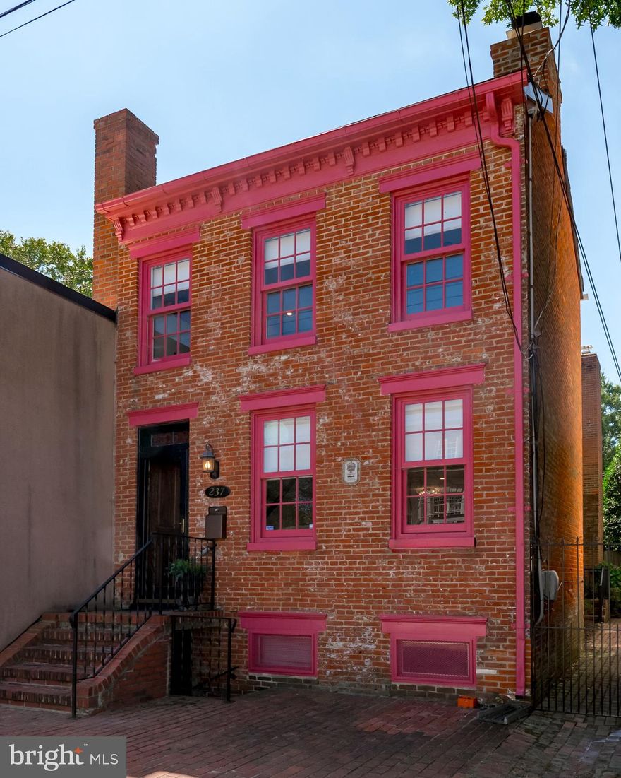 This is a rare opportunity  to own a well-documented (MHA) Greek Revival home on quiet Hanover St. facing USNA across from Officers' Club., very close to Gate 3 and the Navy Chapel (with its wonderful bells).
Fully renovated (managed by architect Gary Schwerzler) with 3 fireplaces (LR FP original marble  with period details recently converted to gas), KT FP wood-burning and Primary Suite FP wood burning (not in use currently) but beautiful woodwork was recently added by master carpenter.
Floors are beautiful Hickory  throughout  LR, DR and KT`- All rooms have large 6 over 6 windows with marble sills  flowing nicely lpast a convenient 1st. floor full bath with a stack Miele washer and dryer.
Continue back to the efficient KT with up to date appliances, gas cooking, new Bosch DW,, granite countertop and eat-at bar.  There is a cozy seating area, wood-burning FP with TV above. In the corner is a new, top-end elevator to 2nd floor! (please do not operate).  Glass doors lead to a fully enclosed, private garden with brick walkway. This is a very special spot, partially shaded by the new deck above - a real retreat in City-living!
Stairs (wth new mahogany railing and period newel post)  lead from front entrance to Primary BR with FP (not currently in use) a corner nook with little desk and 2 set-backs on either side of the FR that could accommodate large bureaus, be enclosed for closets.... this room has a half-wall, opening to the staircase!
An en-suite bath,with marble, tile, nice shower - all re-done complete s this Primary space.
Continuing down the hallway is a similar quality hall bath (also with shower) that serves hall BR that could work beautifully as a home office and the end-of-hall BR (with Amish-built Murphy beds and rolling-door closets.  This BR has glass doors to the newly built IPE upper deck with custom iron railing. This is the upper end for the elevator.
Some important details are the zoned whole house top-end Mitsubishi  HVAC system, and the newly installed sprinkler system.  No detail has gone overlooked.
An unfinished basement has another large washer and dryer, its own HVAC unit and conveniently has its own entrance/exit to the street side of the house.
Thank you for your attention to these details.