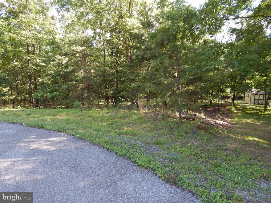 Lot in pristine subdivision with paved roads, underground utilities and community sewer system with 8/10 Acre.  Perfected suited for a full time home or a weekend retreat. Situated on a culdesac, just minutes from Cacapon Resort State Park, offering 6115 acres of outdoor activities, including golf on their 18-hole Robert Trent Jones golf course, swimming in the lake, paddle boats and canoeing, horseback riding, skeet shooting, playground, newly resurfaced tennis courts, paved basketball court or sand volleyball court and vacation cabins. Two areas at the park, the lake and reservoir, offer fishing opportunities. The lake is stocked in the spring for trout fishing, but other fish that can be caught are bass, catfish and blue gill. The reservoir is not stocked. The lodge, along with a restaurant, extend first-class service year-round, with a recent lodge expansion increasing the room inventory by 80 additional rooms including a fitness area, expanded food service, sauna and indoor/outdoor pool, as well as some golf course improvements.