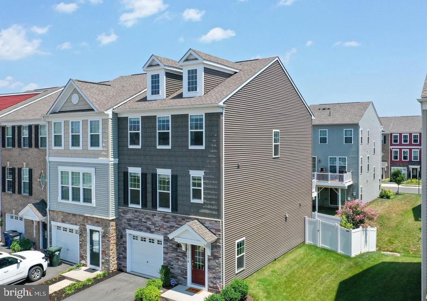 *** Offer Deadline- 05/17/2026*** Welcome to Bradley Square—where refined comfort meets everyday convenience just minutes from the VRE and the charm of downtown Manassas. This impeccably upgraded, nearly 2,300-square-foot townhome offers a polished blend of modern design and thoughtful functionality, creating a residence that feels both elevated and inviting. Refrigerator, Dishwasher and Microwave purchased in 2024.
Outdoor living is equally compelling, featuring a beautifully designed, multi-level paver patio with partial shade and privacy fencing—perfect for relaxing or entertaining—along with a spacious main-level deck finished with sleek vinyl railings.
Inside, the home is defined by soaring ceilings, and abundant recessed lighting that enhances the home’s bright, open ambiance. The entry level welcomes you with a grand foyer and a versatile bonus space—ideal as a fourth bedroom, guest suite, or home office—complete with a full bath and direct backyard access. 
The home also features a fully finished garage designed for both functionality and modern living, complete with a sleek epoxy-coated floor, custom heavy-duty shelving for optimal storage, and a 240V electric vehicle charger—perfect for convenient at-home charging.
The main living level is designed for seamless entertaining, anchored by a chef-inspired kitchen featuring granite countertops, a generous center island, double ovens, a walk-in pantry, and stainless steel appliances. The adjoining dining and family rooms create a fluid, open-concept space perfect for gatherings or quiet evenings at home.
Upstairs, you’ll find three well-appointed bedrooms and a conveniently located laundry area. The primary suite serves as a true retreat, offering dual walk-in closets and a spa-like en-suite bath with a beautifully tiled shower and double vanities. Secondary bedrooms are generously sized, each with ample storage and easy access to a stylish full bath.
Perfectly positioned overlooking community green space and a pavilion, this home offers a tranquil setting with access to exceptional neighborhood amenities, including walking trails, an outdoor fitness area, splash pad, playground, and year-round community events.
With HOA services covering landscaping and trash, and close proximity to shopping, dining, major commuter routes, and the vibrant events of Manassas, this residence delivers a lifestyle of ease and sophistication. A rare opportunity to own a home that truly has it all—style, space, and an unbeatable location.