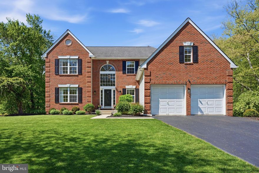 Welcome to 1501 Colonial Drive in the highly sought-after Garnet Oaks neighborhood of Garnet Valley. Known for its wide streets, sidewalks, nature trails, and community playground, Garnet Oaks offers both charm and convenience.  Located within the award-winning Garnet Valley School District, the setting is ideal, with easy access to Routes 322, 1, 95, and 202, nearby train stations, shopping, dining, parks, country clubs, and just a short drive to Center City Philadelphia, Delaware, New Jersey bridges, PHL, and the Media Borough. Set on one of the most desirable lots in the neighborhood, this home offers a rare combination of a walkout basement, a flat and highly usable backyard, and peaceful wooded views. The stately brick exterior and mature landscaping create a welcoming first impression, while a dramatic two-story foyer with a wall of windows brings in beautiful natural light. The main level is centered around an updated eat-in kitchen designed for both everyday living and entertaining. Features include white cabinetry, a large island, KitchenAid stainless steel appliances, gas cooking, granite countertops, tile backsplash, recessed lighting, and a bright breakfast area. The kitchen opens to a cozy family room with a fireplace and access to the deck. A formal dining room, updated powder room, and a convenient laundry room with garage access complete this level. Upstairs, the spacious primary suite offers a comfortable retreat with a large bedroom, walk-in closet, and a sitting area that works well as a home office. The en-suite bath includes a walk-in shower, soaking tub, double vanity, and tile flooring. Three additional generously sized bedrooms and a fully renovated hall bath complete the upper level. The finished basement adds valuable living space and feels like a true extension of the home. As a daylight lower level, it is filled with natural light from a large window and walkout sliding glass doors. It works equally well as a playroom, media room, or additional family space, and also includes a separate exercise room and a large unfinished area for storage. Outdoor living is a standout feature. The custom deck, updated in 2024, offers elevated views and steps down to a patio, creating multiple spaces to relax or entertain. The backyard is flat, open, and incredibly usable, backing to wooded open space for added privacy and a peaceful setting. Whether for play, gardening, or hosting, it is a space you will use every day. The property also offers convenient access to the neighborhood’s HOA trail system and community playground, making it easy to enjoy walks, bike rides, and outdoor time just steps from your door. Additional highlights include hardwood flooring through much of the home, fresh paint in designer colors, a newer roof and heater, new washer and dryer, smart home features, public utilities, natural gas, and a low-maintenance exterior. This home offers a wonderful combination of space, condition, and location and is truly a must-see.