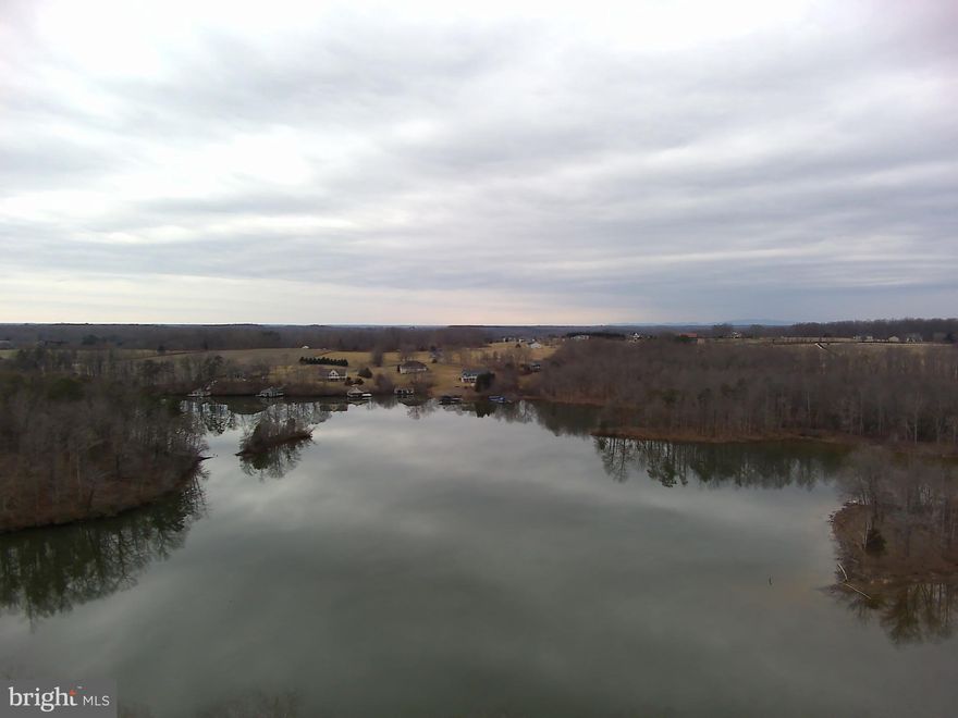 A rare opportunity to own 12.19 contiguous waterfront acres on Lake Anna, featuring approximately 398± feet of exclusive shoreline rights, sweeping water views, and exceptional privacy.

Imagine winding down your own long private driveway toward a rare stretch of Lake Anna shoreline, where the property opens to sweeping water views and the feeling of having space to create something truly special. It is the kind of setting where a dream lake estate, family compound, or legacy retreat can take shape.

As you explore the land, a quiet connection to the past reveals itself. Hidden among the trees, the stone fireplace from a homestead that stood here long before Lake Anna existed still remains. In the spring, daffodils bloom around the old homesite tucked among the trees, offering a beautiful reminder that this land was once home to others and still carries traces of its past. It is a rare and almost storybook detail that adds soul and history to an already remarkable waterfront setting.

Comprised of a 3.12-acre parcel and an adjoining 9.07-acre parcel, the property offers an extraordinary combination of scale, beauty, and flexibility that is increasingly difficult to find on Lake Anna. The 3.12-acre parcel provides a premier waterfront homesite with a beautiful gradual approach to the lake, while the 9.07 acre parcel offers multiple potential building sites, sweeping lake views, and subdivision potential.

Together, the parcels create a rare opportunity to shape a one-of-a-kind private retreat, multigenerational estate, or investment opportunity. Large waterfront tracts of this size are rarely available on Lake Anna. With over twelve acres of contiguous land, nearly four hundred feet of exclusive shoreline rights, beautiful water access for boating and swimming, and the flexibility to create something truly personal, this is a rare opportunity to build a legacy waterfront property designed to be enjoyed for generations.

Plat and surveys provided for reference only, including the plat dated from 2011 depicting the 9.07-acre parcel together with an older configuration of the former 3+ acre parcel, the updated survey for the current 3.12-acre parcel dated 2021, and the plat of exclusive shoreline rights. The exclusive shoreline rights plat shows an approximately 0.526-acre shoreline-rights. An underground electric utility easement runs through a portion of the property serving an adjoining parcel and may offer convenient access to electrical service. Buyer to verify boundaries, acreage, shoreline rights, survey information, subdivision potential, utility availability, easement location, capacity, and connection requirements, and all material facts independently. 

Buyer Agents Welcome.