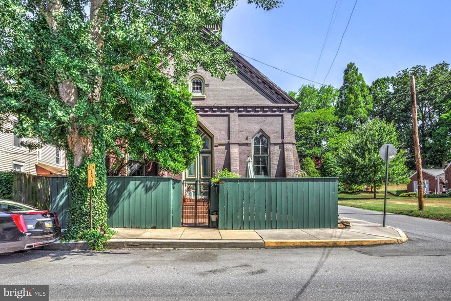 One of a kind condo, in a one of a kind building!  Marietta's Gothic Lofts Condominiums offer a uniquiness you'll find hard to locate anywhere nearby.  This 2 Bed/2 Full Bath unit has soaring cathedral (literally) ceilings, open concept floor plan and a nice mix of modern conveniences and yesteryear craftsmanship.  The layout is ideal with the first floor main bedroom and ensuite full bath.  The colorfully fun kitchen is perched slightly above the main space and features a butcher block countertop, a double basin sink, a dishwasher and unobstructed access to family and friends as you prepare dinner and drinks for the night ahead.  This entire space is especially cozy in colder months when the wood burning fireplace is in use.  Head to the 2nd floor on the open staircase with wrought iron railings and you'll find the 2nd bedroom and 2nd full bath.  This space could be used in so many ways: guest room, office, studio, gym, library.  The arched doorways are super charming, as are the built-in bookshelves, skylights, brick path entry.  One car offstreet parking in the back, and plenty of on street parking out front.  Basement is common area and can be used for some storage.   This is really one that needs to be seen to in order to be fully appreciated.