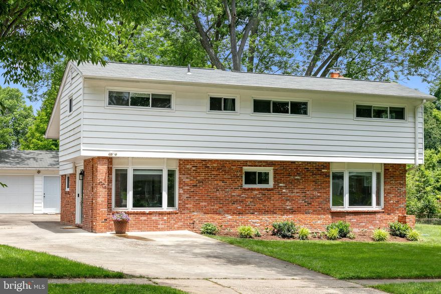 Welcome to this meticulously maintained Twinbrook abode, exuding personality and updates at every turn! As you arrive, you'll appreciate the detached 2-car garage equipped with a wired workshop, along with a driveway that can accommodate 4+ cars. Step inside to the spacious foyer featuring custom built-ins for your storage needs. The gourmet kitchen is complete with granite counters, custom cabinets, wine fridge, bev fridge, island seating, a large pantry, and stainless steel appliances (including a new fridge bought in 2024 and a dishwasher in 2017). Adjacent and open to the kitchen, the sunlit dining room showcases a bay window with charming built-in banquette. The great room is an ideal gathering spot with soaring cathedral ceilings, gleaming hardwood floors, and a stunning stone fireplace. Off the great room is a deck that overlooks the expansive, private backyard—great for outdoor entertaining and relaxing! Head upstairs to discover three generously sized bedrooms, two recently updated bathrooms, and convenient laundry with a newer washer and dryer bought in 2022. The primary bedroom is your personal sanctuary, boasting an ensuite bath complete with a new vanity and a groovy glass block shower, as well as a spacious walk-in closet. The lower level provides versatile flex space, perfect for a home office, playroom, or gym. The HVAC system was replaced in 2020, and the hot water heater was replaced in 2021, ensuring comfort and efficiency. All this in an amazing location! Situated on one of the biggest lots in the neighborhood, just 1 mile to Metro and the brand new Twinbrook Quarter development, including the soon-to-open Wegmans. One block to the Twinbrook Library and just 0.2 miles to an array of restaurants. Also, convenient to shopping, schools, and many walking/biking trails, including Rock Creek Park. Don’t miss the opportunity to make this delightful home your own! Offers due Mon 6/10 by 6pm