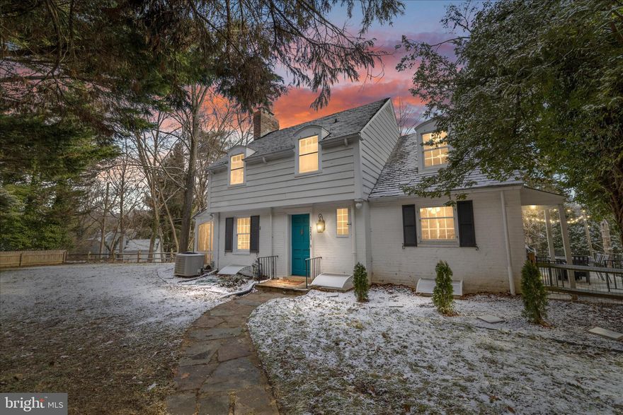 Hidden along the wooded curves of the Gwynns Falls, the historic village of Dickeyville feels like a place quietly borrowed from another time. Cobblestone roads wind past stone cottages, where neighbors gather for pancake breakfasts and parades, and the sound of the river and rustling trees replaces the city hum—yet all of it sits just minutes from the heart of Baltimore.

This enchanting 1940s Colonial is a true reflection of its setting: whimsical, storied, and rich with original detail. From the moment you step inside, you’re greeted by beautifully preserved hardwood floors, historic interior storm windows, and the kind of old-world craftsmanship that’s increasingly rare—substantial stonework, solid wood doors, and original window and door hardware that feels more like art than utility. Two fireplaces anchor the home with warmth and character, inviting slow evenings and cozy gatherings.

Thoughtful updates blend seamlessly with the home’s historic soul. The kitchen has been renovated for modern living while remaining connected to the heart of the home, opening easily into dining and living spaces filled with natural light. A flexible main-level room—perfect as a bedroom, studio, or home office—offers private porch access and a peaceful connection to the outdoors.
Upstairs, generously sized bedrooms are anchored by a thoughtfully updated ensuite bath, offering modern comfort while the remaining original bath preserves the home’s historic character. The finished walk-out basement adds even more versatility with a rec room, full bath, and ample storage—ideal for guests, creative space, or hobbies.

Outdoors, the property sits on one of the largest lots in the village, surrounded by mature trees and lush landscaping. Multiple patios, a screened three-season porch, and a fully fenced yard create a setting that feels both secluded and communal. Rare for the neighborhood, the home also offers exceptional parking: a two-car parking pad plus two separate one-car garages, along with a private drive—providing space for guests, hobbies, or everyday ease without sacrificing charm.

Dickeyville is listed on the National Register of Historic Places and is one of Baltimore’s earliest and most complete examples of a preserved 19th-century mill village—a neighborhood where history is not just remembered, but lived. With a voluntary village association and a calendar full of traditions, this is a place where neighbors know one another and homes tell stories.
Step into Dickeyville, and into a home where craftsmanship, nature, and community come together—ready for its next chapter.

*NOTE* Although the legal address is 2441 N Forest Park Ave, the property is not accessed from N Forest Park Ave. All access is via Pickwick Rd. For GPS and showings, please use 2440 Pickwick Rd, Baltimore, MD 21207, which will bring you directly to the driveway and entrance