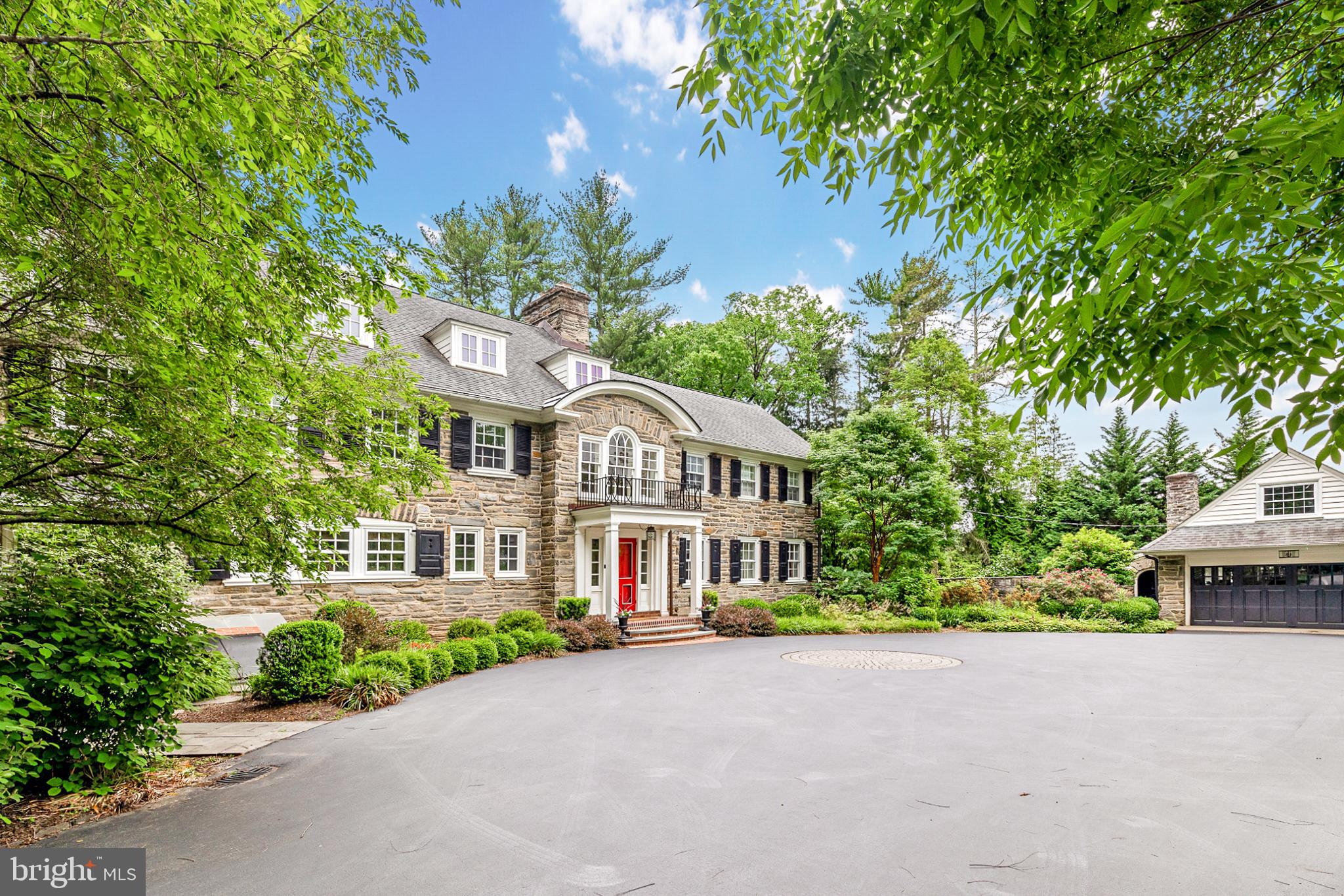 Rarely does a home so elegant and timeless, in a prestigious & coveted location become available. Situated on Merion Golf Club’s East Course overlooking the first green, this Quintessential Main Line Stone Colonial is the perfect blend of stunning curb appeal, large open rooms, and enchanting outdoor living spaces. Stone Pillars and manicured landscaping welcome you to this Grand Estate. Enter the wide foyer and you are immediately enveloped in sunlight, warm hardwoods, luxurious finishes, charming arched doorways, crown molding and ornate wainscoting details. A large dining room can accommodate your largest gatherings, three built-in china closets will delight you, and french doors to the bluestone patio make for effortless flow while entertaining. The formal living room is light and bright with a wood burning fireplace and opens to a fabulous expanded family room featuring exposed stone walls, french doors to the patio and built-in bench seating under the walls of windows overlooking the gardens, the perfect spot to enjoy a book and the views! The gourmet eat in kitchen, accessed through an intelligently designed butlers pantry complete with prep sink, sub zero wine fridge, Miele dishwasher and glass front china storage, is a chef's dream anchored by a large seated island. Marble counters and white custom cabinetry make this space light and airy, while a 6 burner Wolf Range, 2 Miele ovens, a mixer lift cabinet and a SubZero refrig ensure state of the art functionality. The large island has seating for four, two SubZero refrigerator drawers, a prep sink and butcher block. The kitchen is open to a breakfast room/ family room with built-ins and french doors opening to the back gardens. A mudroom with sink is off of the kitchen and features built-ins, storage and an entrance to the backyard perfect for pets. A lovely updated powder room with designer wallpaper and entry closet completes the main level. Every room along the backside of this home has french doors opening to the expansive flagstone patio overlooking the breathtaking grounds which were modeled on the work of Thomas Sears. The over 1.8 acre lot is truly a respite from the outside world, with mature specimen plantings bordering the grounds allowing for peekaboo views of the golf course beyond, a gorgeous pool, numerous blue stone patio seating areas and a fountain with a lily pond. The wide staircase with arched windows on the landing leads you to the upper level. The primary bathroom has been updated with Marble tile, two vanities with marble tops, a steam shower with frameless glass door, linen closet and a soaking tub with fabulous views of the grounds. The bedroom is generously sized and is lined with closets, and a custom walk-in closet completes this bedroom retreat. A large office/den has french doors that open and overlook the impressive grounds below a quiet sanctuary. Two additional bedrooms each with their own en suite baths offer large spaces and ample closets. The large laundry room has a rinse sink, built-in cabinetry and ironing board. Original linen drawers and cabinets line the wall heading to the third floor, perfect for linen storage. The third floor features four additional bedrooms, a full bath with shower and a spacious cedar storage room! The lower level of this home is unfinished-but currently has a work out room, storage area, sauna room, wine room and canning kitchen! Outside find a 2+ car garage with ample storage, an attached potter's shed and riding mower storage. All the systems and mechanicals have been updated including a new boiler(2021), on demand hot water heater, newer roof, windows and doors are just a few of the latest improvements. The entire home has been updated and renovated to the highest quality standards with special attention to adhering to the quality and craftsmanship of the era. Make this stunning home within walking distance to Merion Golf your forever home by calling for your appointment today!