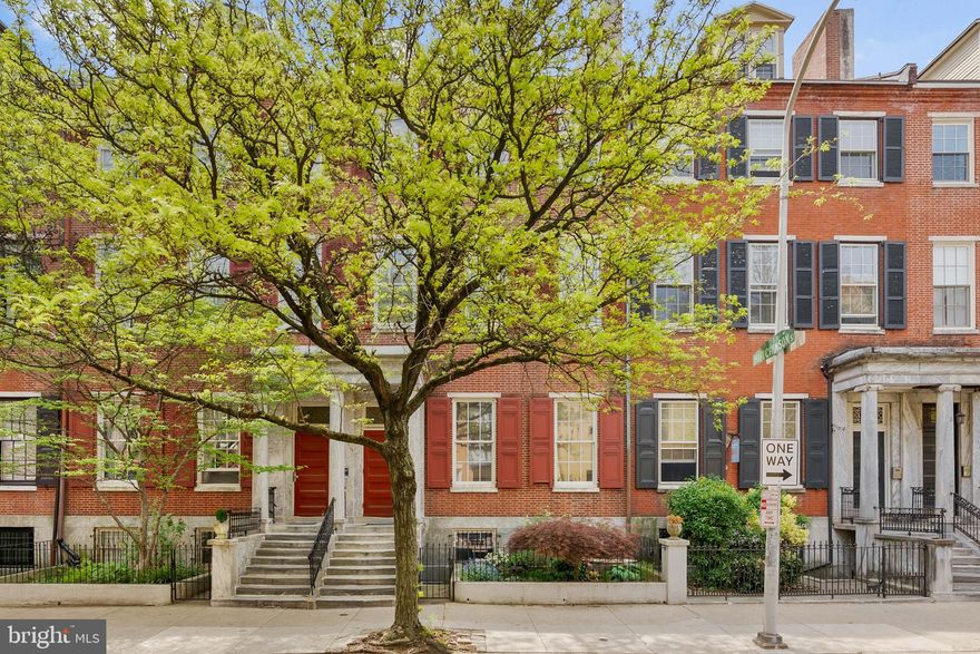 Located in a pridefully preserved condo building along the tree-lined Portico Row block of Washington Sq West, 914 Spruce St #9 is a large, extra-wide unit offering 2 bedrooms, 2 bathrooms, in-unit laundry, and a dedicated parking spot right out back. Out front, the property displays classic Philly architecture with a towering red brick facade, a vibrant garden, a marble portico, and a secure entry. Inside the unit, you're welcomed by a foyer with a deep storage closet. Beautifully aged hardwood floors extend into the expansive main living space that boasts soaring ceilings, a pair of tall windows, and a fireplace. There's plenty of room for hanging out and entertaining. The updated kitchen has generous cabinetry, granite counters, and a full suite of stainless steel appliances, including a dishwasher and convection oven. Down the hall is a bright and airy primary bedroom suite with more picturesque windows, a walk-in closet, and an attached full bathroom with bidet. Completing the unit is a second bedroom with a custom closet, another full bathroom, and a laundry closet. Additional highlights include a parking spot that's accessed from the rear of the building, central a/c, electric heat, and electric hot water. 914 Spruce St's sought-after location earns a Walk Score of 95! It's only a few blocks from Center City, yet it has a small community feel. Local favorites like Habitat Coffee House, and Kanella Grill are just steps away. Nearby 13th Street, known as Philly's restaurant row, features beloved spots including Little Nonna's, Vetri Cucina, Green Eggs Cafe, and Flambo. Enjoy sprawling green space at idyllic Washington Square Park, or stay active at Seger Park with its tennis court, dog park, and playground. A stroll down 9th leads to vibrant South Street, home to markets, shops, and eateries like Whole Foods and ACME. With Jefferson and Pennsylvania Hospitals within walking distance and a direct bus line to the University of Penn right on the corner, convenience is at your doorstep. Schedule your tour today!