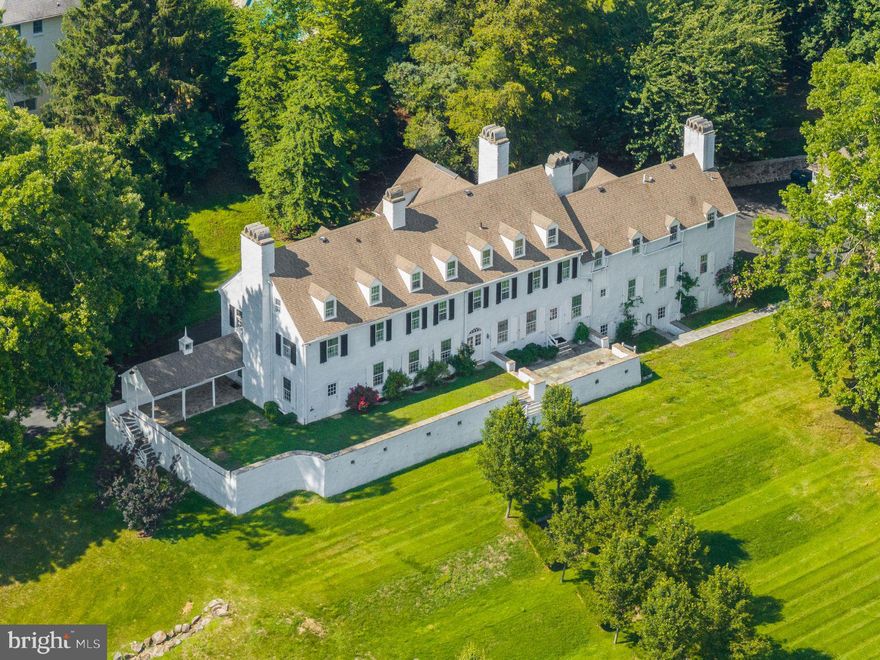 Steeped in history and rich in architectural character, 1266 Gulph Creek Drive is more than a home, it’s a lifestyle. Offering over 8,100 square feet of flexible living space on 2.3 beautifully landscaped acres in Wayne, Pennsylvania, this extraordinary property feels like a private country retreat yet is only minutes from the Main Line and Center City Philadelphia. Originally part of William Penn’s Manor of Mount Joy and later the Van Pelt family estate known as “Woodstock,” the property has deep historical roots. In 1927, renowned architect R. Brognard Okie thoughtfully expanded and refined the home, blending timeless craftsmanship with comfort and livability. You’ll find random-width pegged floors, intricate millwork, and custom built-ins that bring warmth and authenticity to every room. The home’s layout offers remarkable versatility for modern life, ideal for multi-generational living, work-from-home lifestyles, or hosting guests in style. Gracious living and dining rooms flow to a cozy library and inviting kitchen that connects easily to the upper levels via a back staircase. With 11 fireplaces, abundant natural light, and a seamless floor plan, the home feels both grand and welcoming. There are nine bedrooms and eight baths, including a spacious primary suite with a walk-in dressing room and spa-like bath, plus a junior suite with easy access to the kitchen,  perfect for guests, an au pair, or extended family. The third floor offers even more flexibility with additional bedrooms, baths, and laundry. Outside, lush lawns, mature trees, and stone pathways create a serene, private setting; a peaceful escape that still keeps you close to award-winning schools, shops, and restaurants. Historic touches like the original spring house and root cellar remain, preserving a tangible connection to the past. A rare opportunity to own one of Montgomery County’s most distinguished historic estates, 1266 Gulph Creek Drive combines timeless architecture, a rich story, and endless possibilities for today’s lifestyle, all within minutes of everything the Main Line and Philadelphia have to offer.