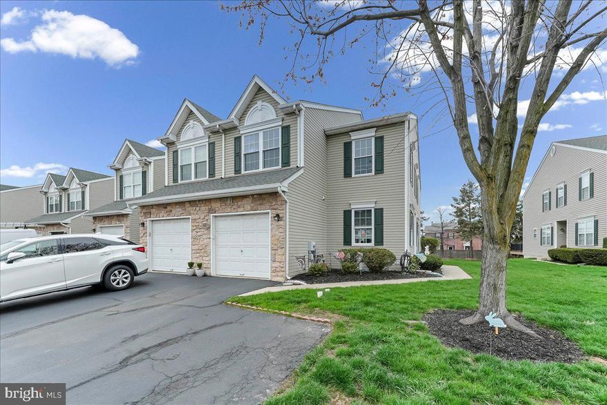 Welcome home to this inviting end-unit townhome, offering the perfect blend of space, comfort, and everyday functionality. From the moment you step inside, you’re welcomed by a bright foyer with tile flooring and an open view to the second floor, creating an airy first impression. The main level features a thoughtful layout with a living room with hardwood floors, a dining room with tile flooring, and a kitchen designed to be the heart of the home. It offers white cabinetry, granite countertops, sliders to the deck, and a seamless flow into the family room creating a cozy yet open living space. Both the kitchen and family room feature hardwood floors, and the sliders lead to a private deck, perfect for morning coffee or relaxing evenings. Also on this level, you’ll find a powder room and a convenient laundry area with direct access to the attached one-car garage. In addition to the garage, there is parking for two more cars plus ample street parking for guests. Upstairs, the home offers three generously sized bedrooms and a full hall bath. The primary suite is a true retreat, complete with a walk-in closet, a sitting area, and a spacious ensuite bath featuring a soaking tub, stall shower, and double vanity. The partially finished full basement provides valuable bonus space ideal for a home office, gym, or recreation area while still offering plenty of storage. This home combines comfort, style, and practicality in a sought-after community.
