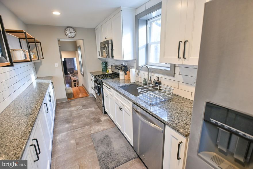 Welcome home to this spacious, updated Butchers Hill/Washington Hill rowhouse. Hardwood floors span the living room and adjacent dining space, while a well appointed kitchen extends to the back of the mail level. Enjoy the extra counter space and cabinets in this gourmet kitchen, with granite countertops and stainless steel appliances. Ascend to the second floor to one of two bedroom suites. Double doors lead to a sunny, East-facing bedroom with a large walk-in closet and en-suite bathroom with a tub/shower combo and lots of space for storage. Continue up to the third floor. Enter through double doors for the second bedroom suite, also with an en-suite bath and large closet. On the lower level, there is a bonus/flex space that could be used as another bedroom, family room or entertainment area, with a half bath and door that opens to step up to the street in front of the house. In the back of this lower level is a large laundry and storage area, with a door leading to the back yard/deck. Walk to the Johns Hopkins Medical Campus, downtown, Fell's Point, Patterson Park, Ministry of Brewing, Marta, Charmed Kitchen, Whole Foods, and Safeway, to name a few.  Recent improvements include New Roof, New French Drain and Sump Pumps (2), New Carpet on Lower Level, New HVAC and New backyard fence.