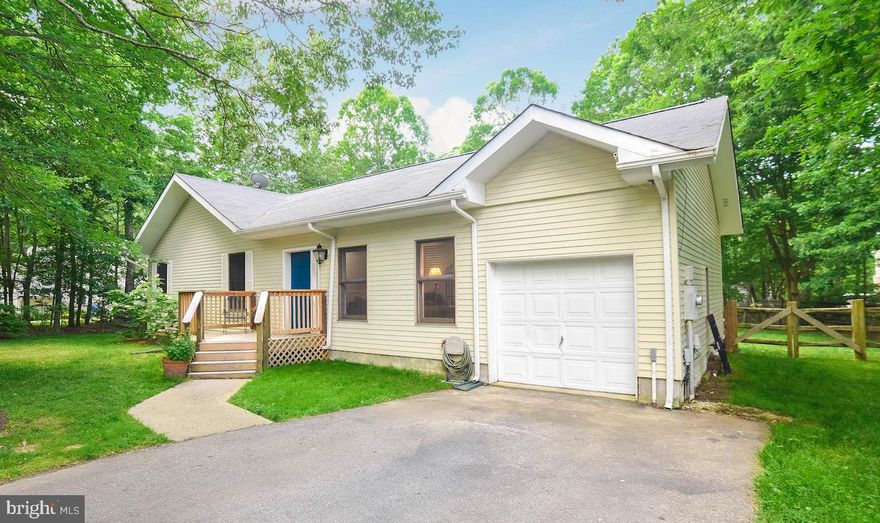 Peaceful & Private describes this home and location!   The foyer opens into the family room with views into the dining room and kitchen.  Vaulted ceilings with beams and skylights allow for a spacious and light feeling throughout the main area of the home.   Luxury vinyl flooring in both the kitchen & dining rooms.  The kitchen has a laundry/pantry area conveniently located just off of the garage.  The back door in kitchen opens to the deck great for a morning cup of coffee or evening cookouts.  The back yard is fenced and private.  This home has 3 bedrooms and 2 full bathrooms and sits on just under an acre.  The master bedroom is large with vaulted ceilings, walk in closet and master bath.  There is also a door leading out to the deck from the master bedroom.  The one car garage allows for parking and storage space with pull down attic storage.  New Roof and skylights.  Golf & Pool memberships are available through the Breton Bay Golf & Country Club.  Beach access is also available for $50 per year through the Breton Bay Civic Association.  Beach area includes a pier, playground, and pavilion area.   Close to schools, shopping and downtown Leonardtown.