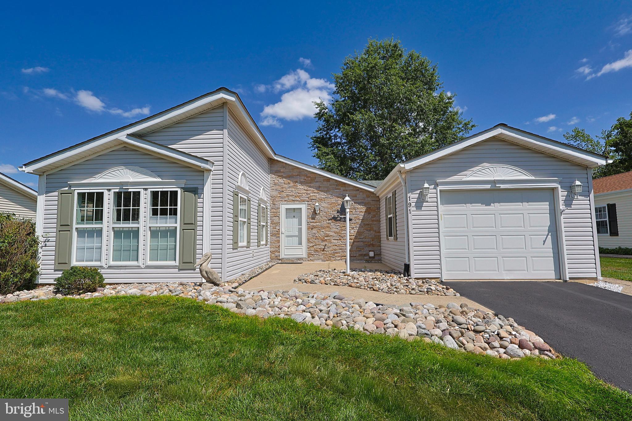 Downsize in style without giving up the comforts you love! This beautifully updated 2-bedroom, 2-bath home, in the highly desirable active adult community of Buckingham Springs, offers a perfect blend of elegance and convenience. Step inside to discover a bright, open floor plan with an updated kitchen, a tastefully renovated hall bath, and a spectacularly reimagined primary suite with a luxurious en suite bath. A versatile den opens to a private deck with a custom awning—ideal for relaxing or entertaining. An attached garage adds everyday ease and additional storage options. Throughout this inviting home, you’ll find thoughtful upgrades and flexible spaces designed to fit your lifestyle and make every day feel like a retreat. <<---ABOUT THE COMMUNITY--->> At Buckingham Springs your community fee not only includes the basics such as sewer, trash, and common area maintenance, but gives you access to community perks such as an elegant clubhouse with an outdoor heated swimming pool and spa, private bus service for shopping and regularly scheduled outings, professional on-site management including an activities director, and a host of fun-filled activities to enjoy! All of this is just minutes away from the shopping, dining, and recreation of New Hope, Peddler's Village, Doylestown, and Newtown. Come see what 191 Cardinal Court has to offer you.